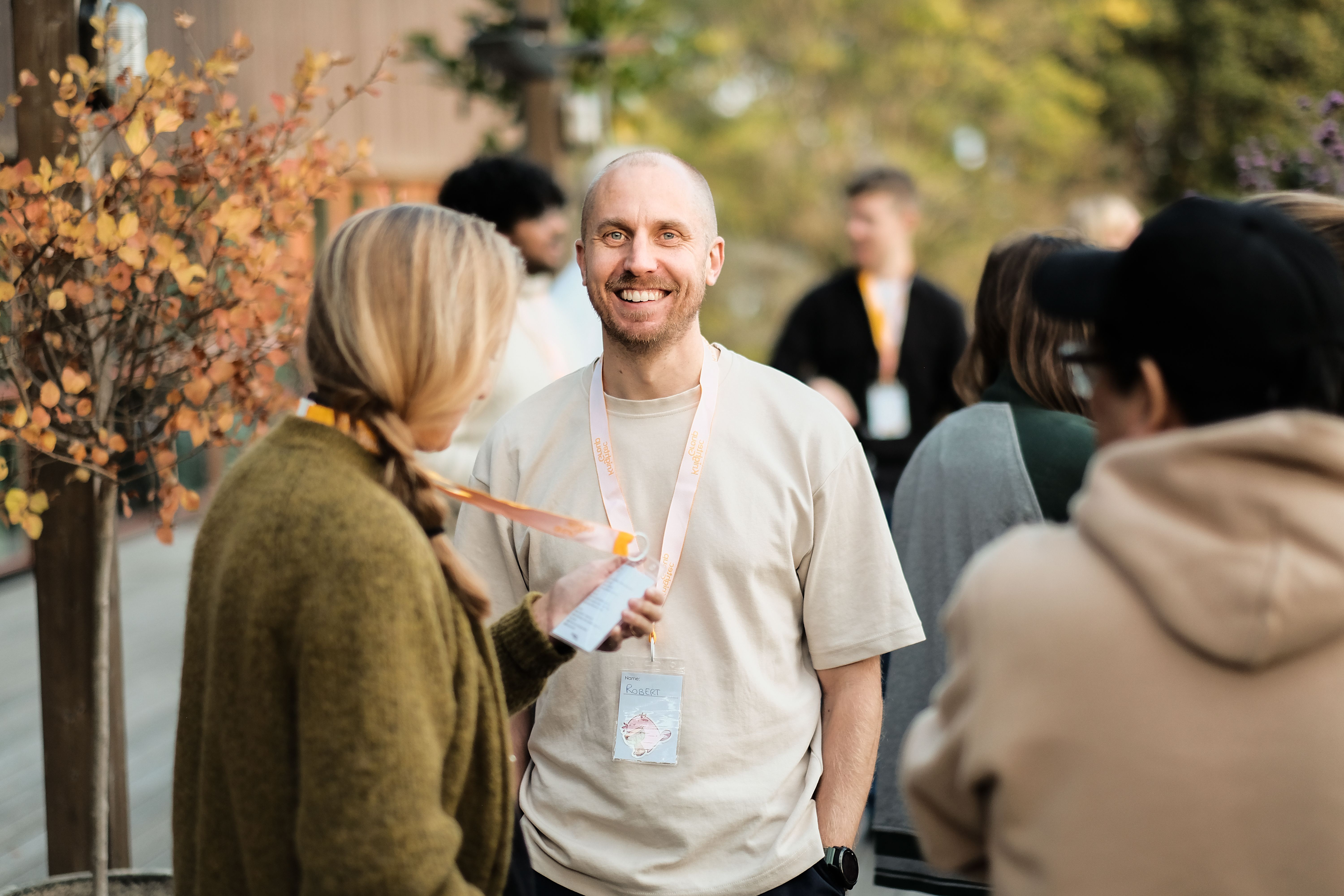 Two people standing in an outside setting amongst other people