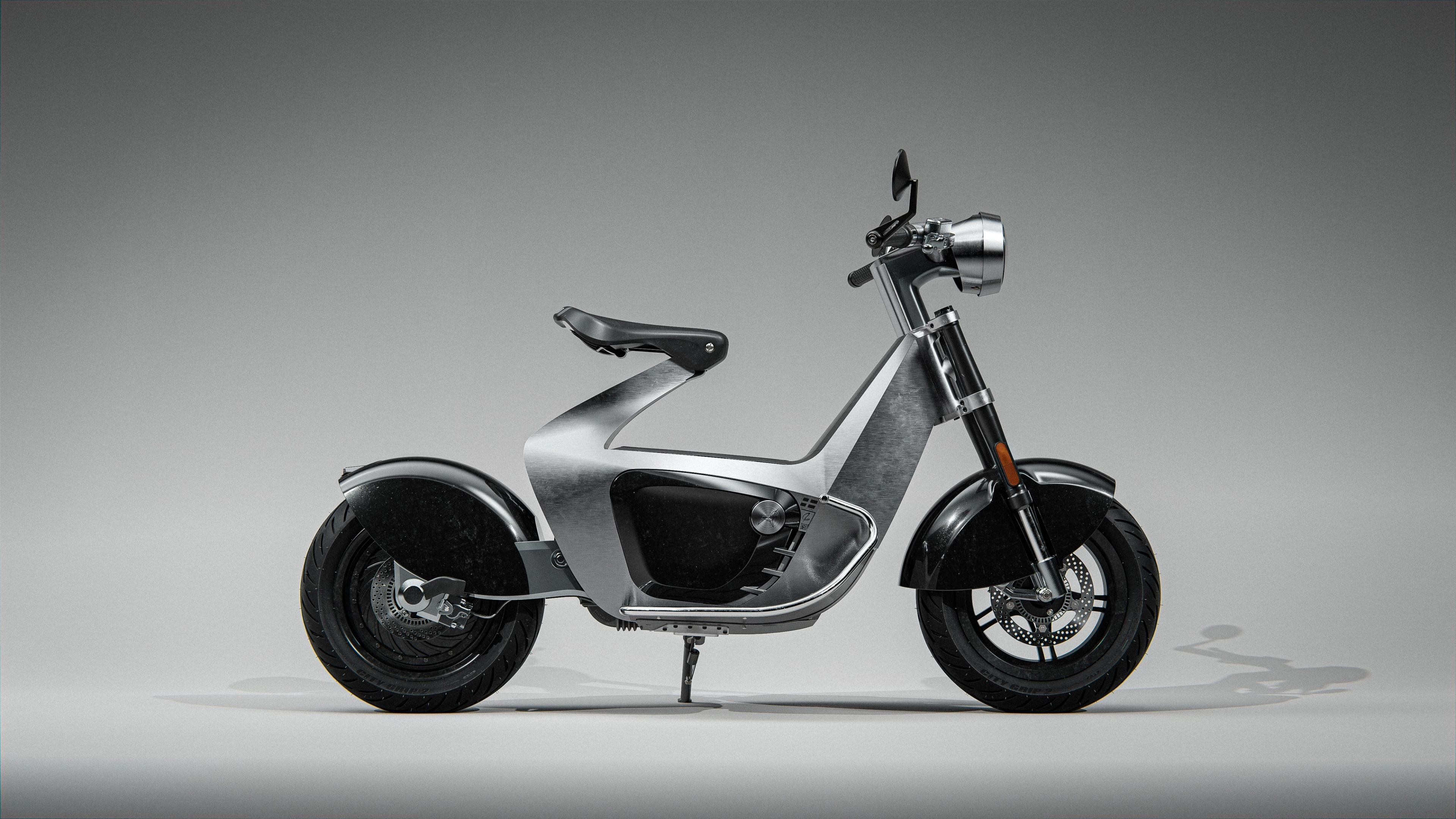 Modern electric scooter displayed in a studio setting.