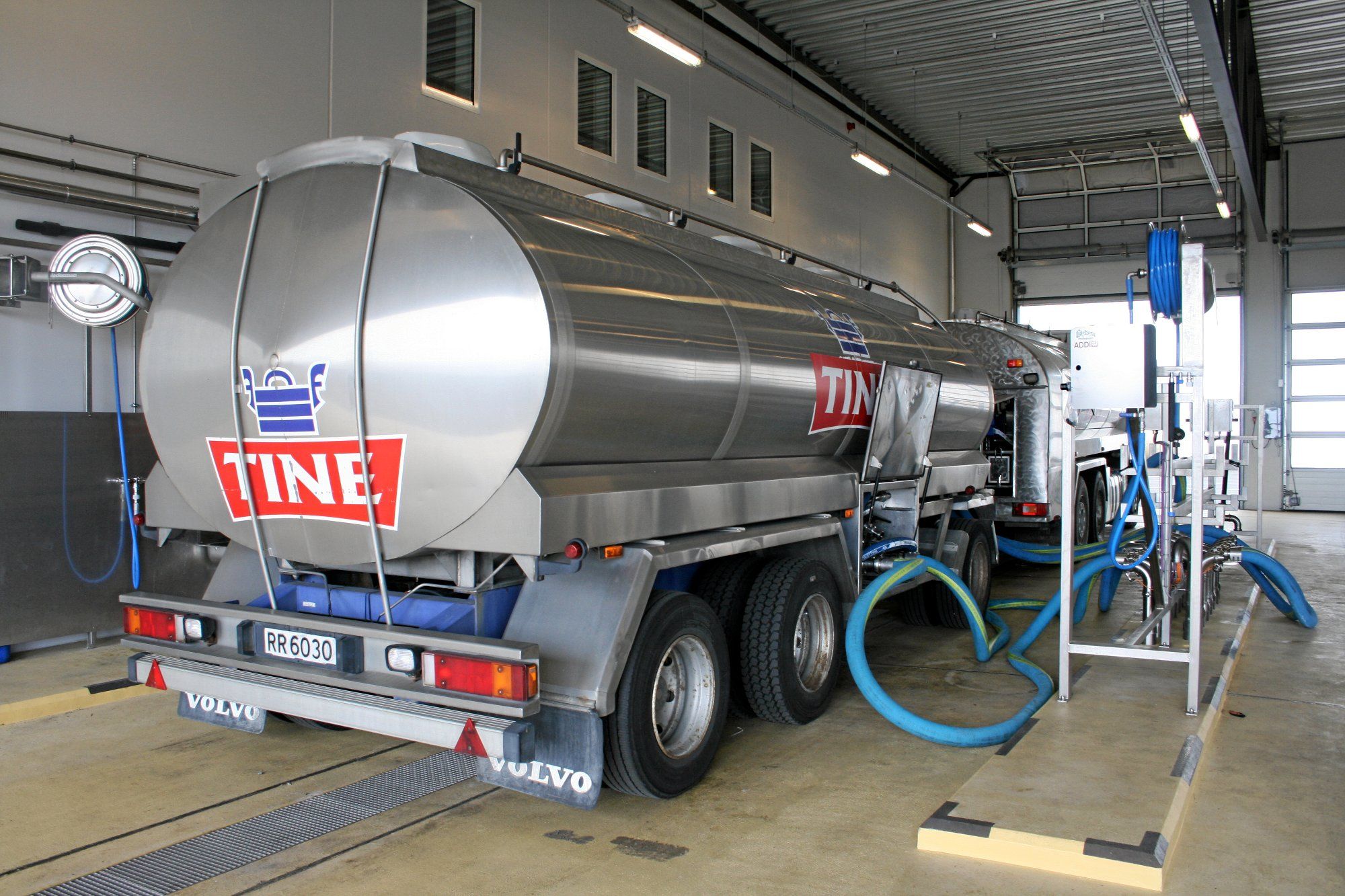 Milk tanker filling up milk.