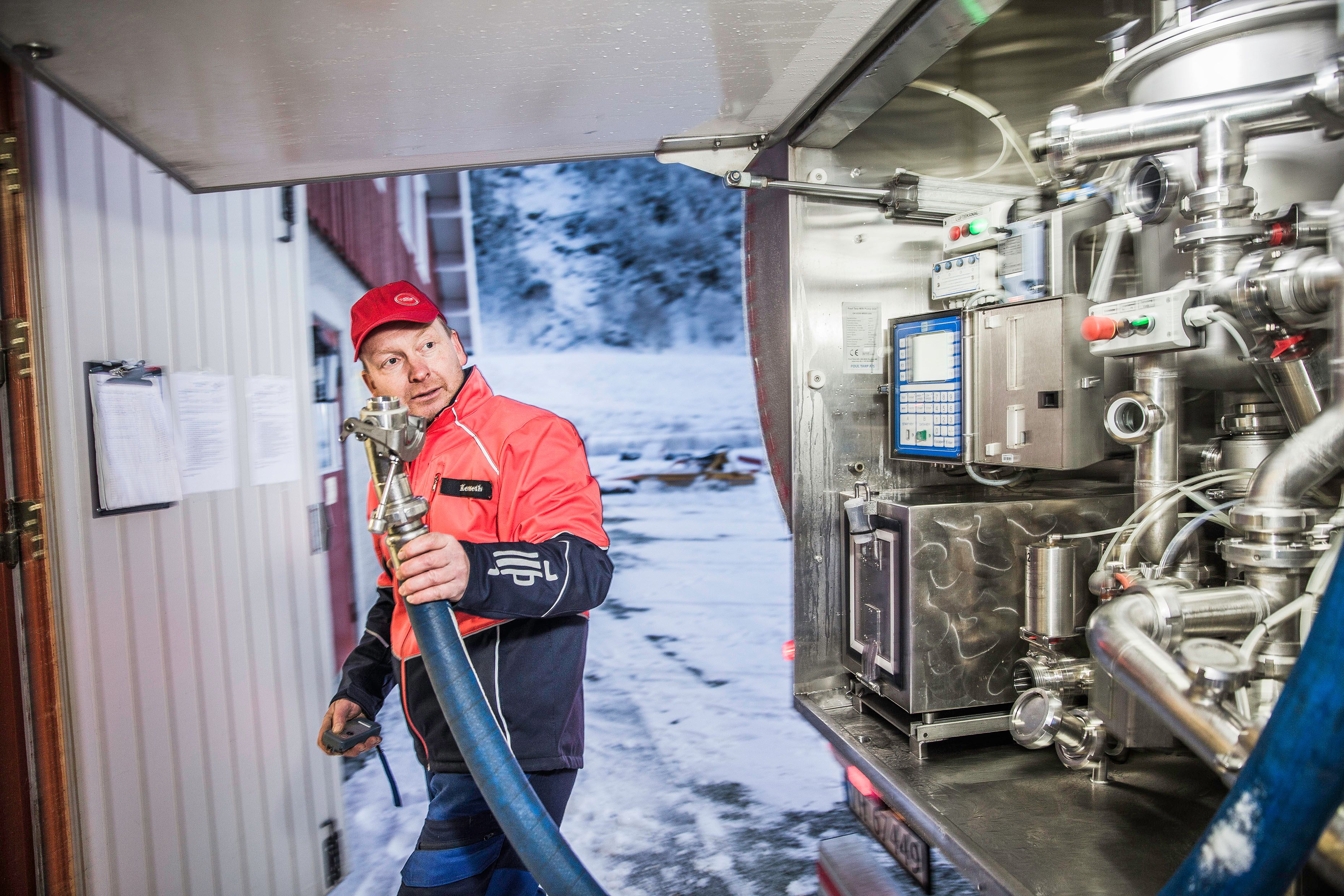 Man working with a milk machine.