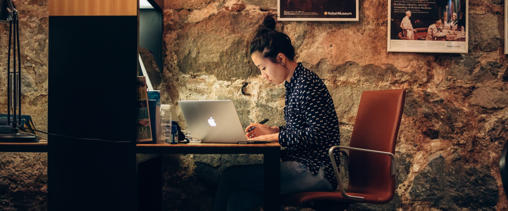 Image showing a woman sitting by a desk