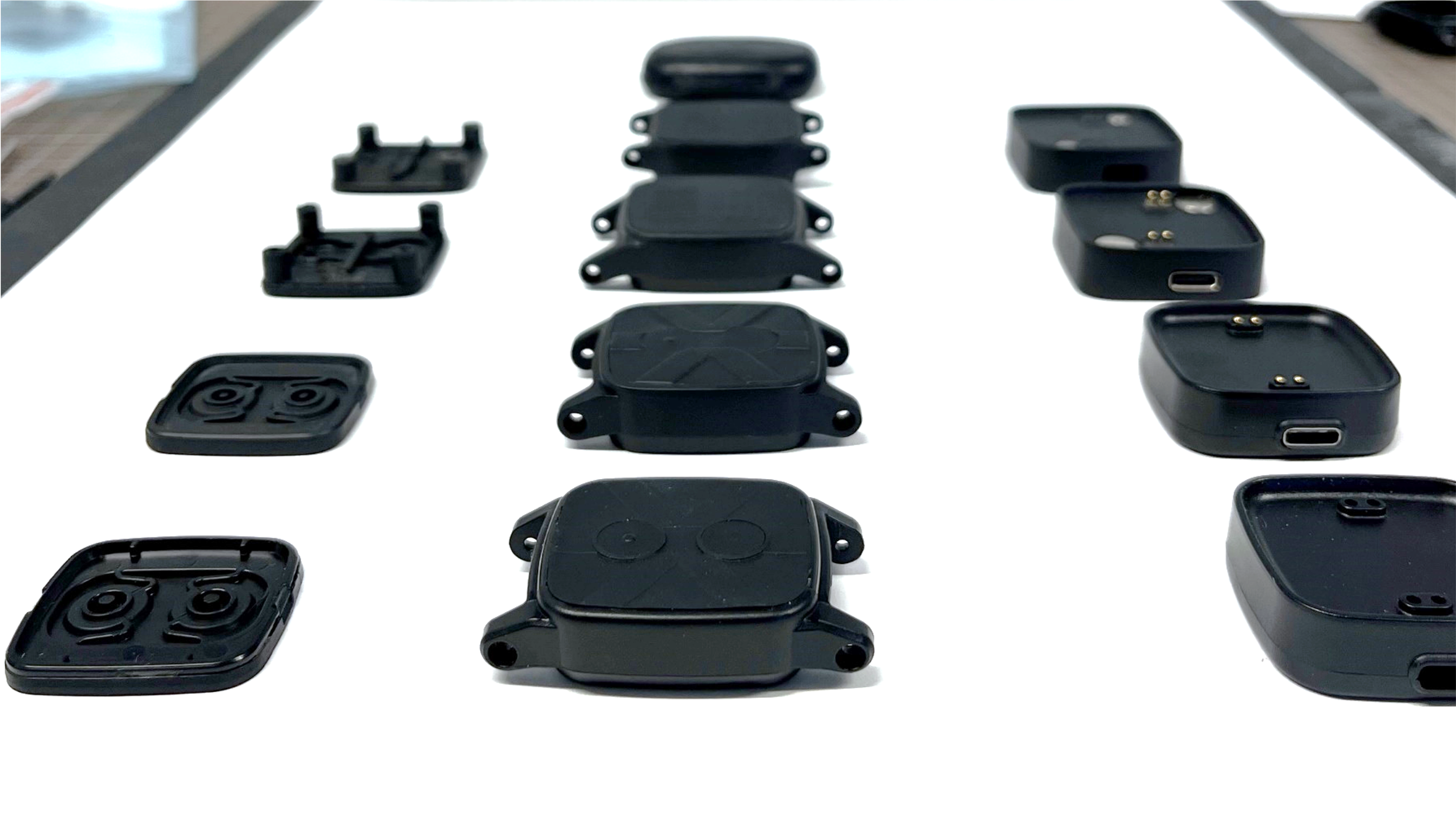 Several watches a prototypes on a table.