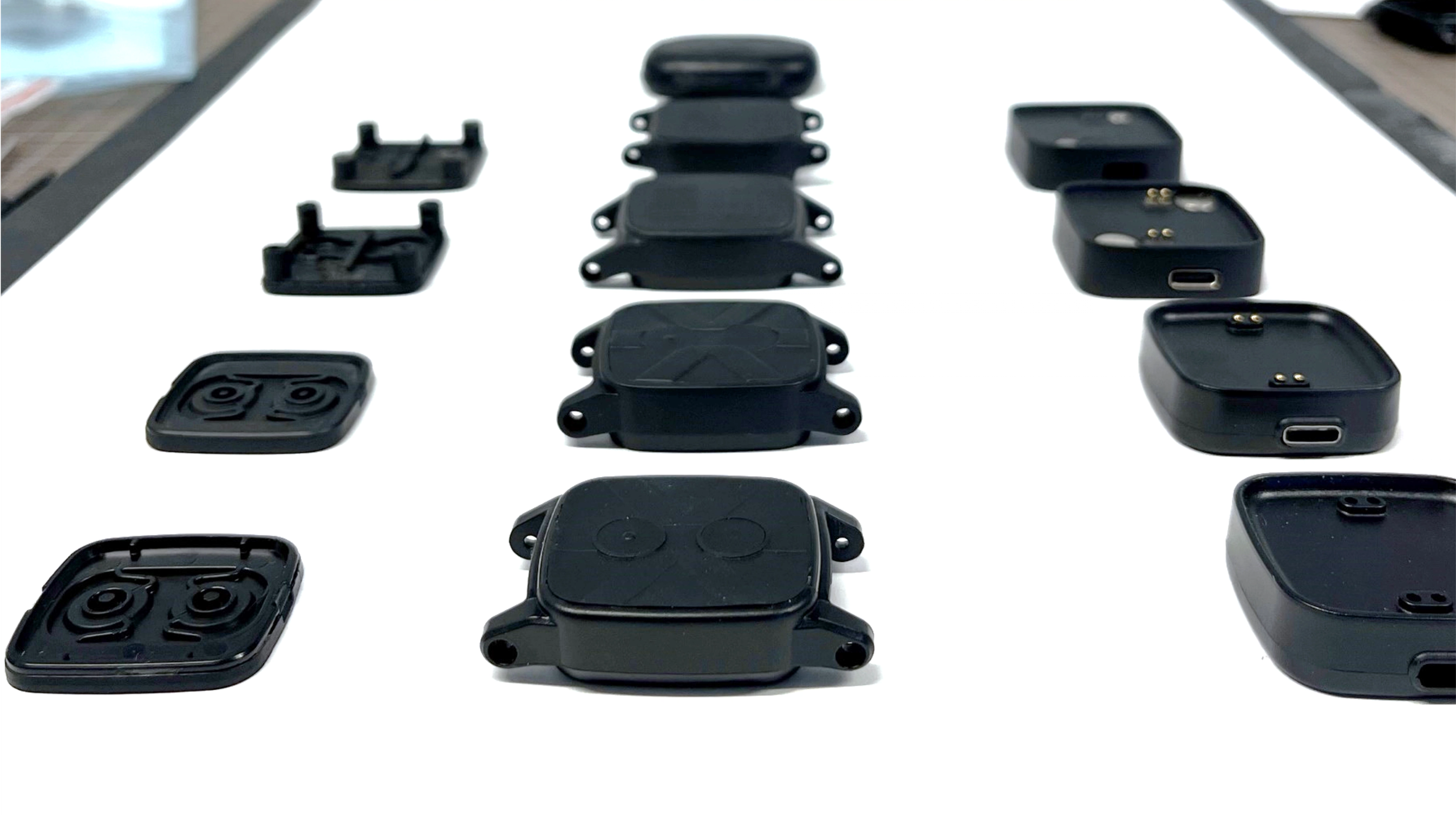 Several watches a prototypes on a table.