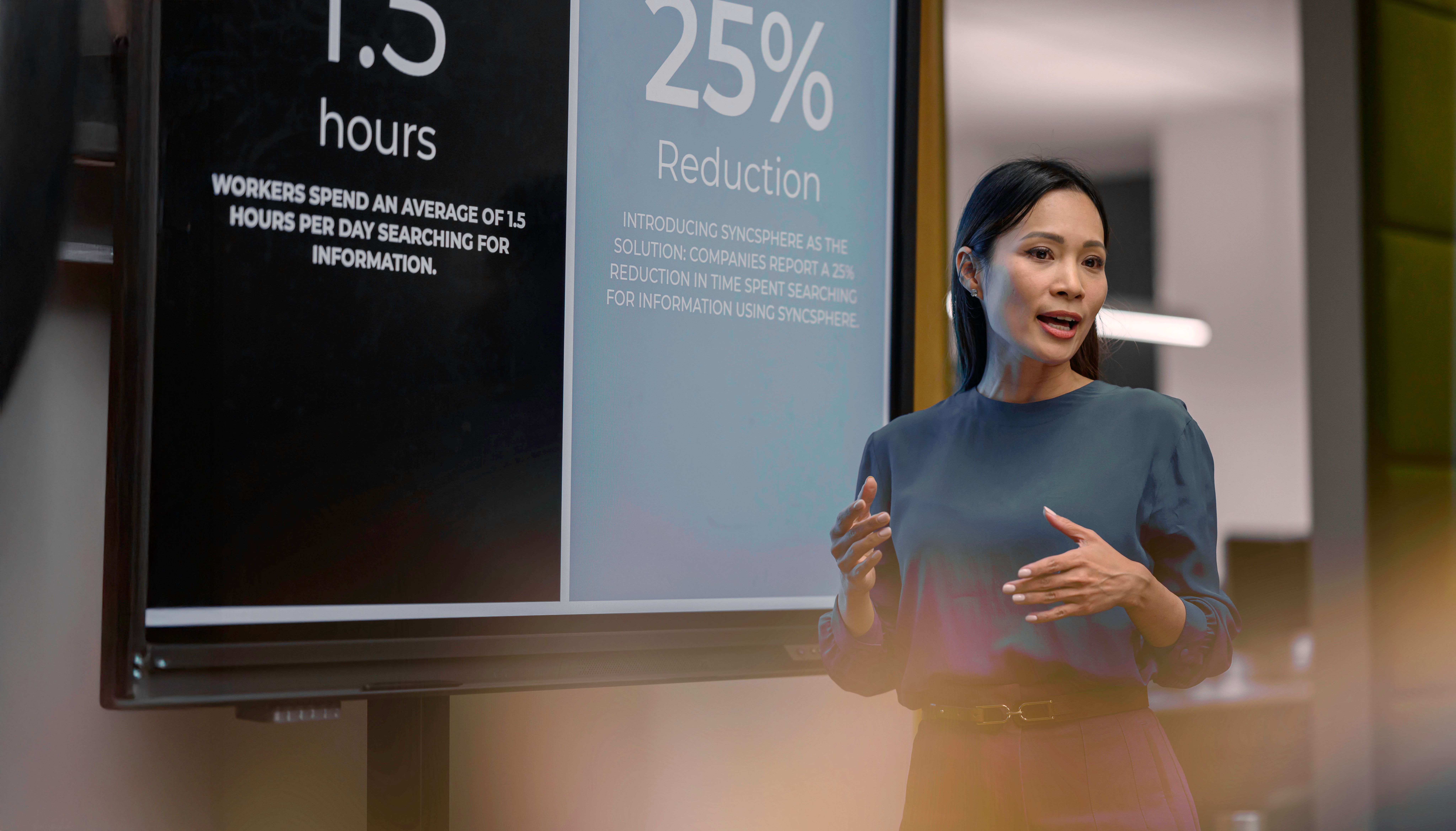 A women standing in front of a TV screens talking