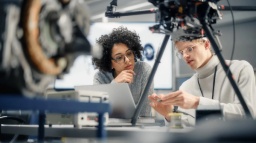 Two persons holding a AI-ship