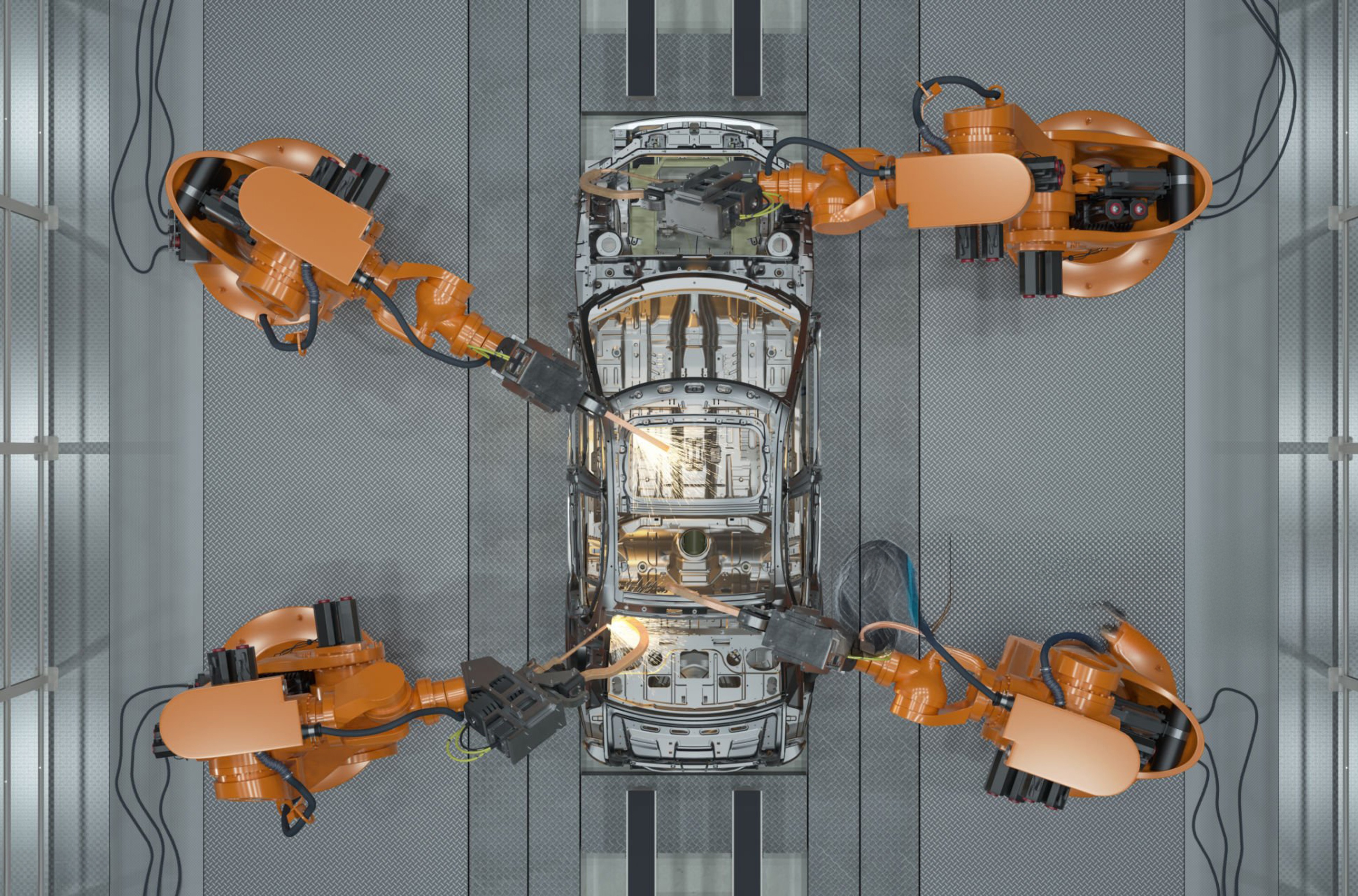 Four robotic arms working on a car