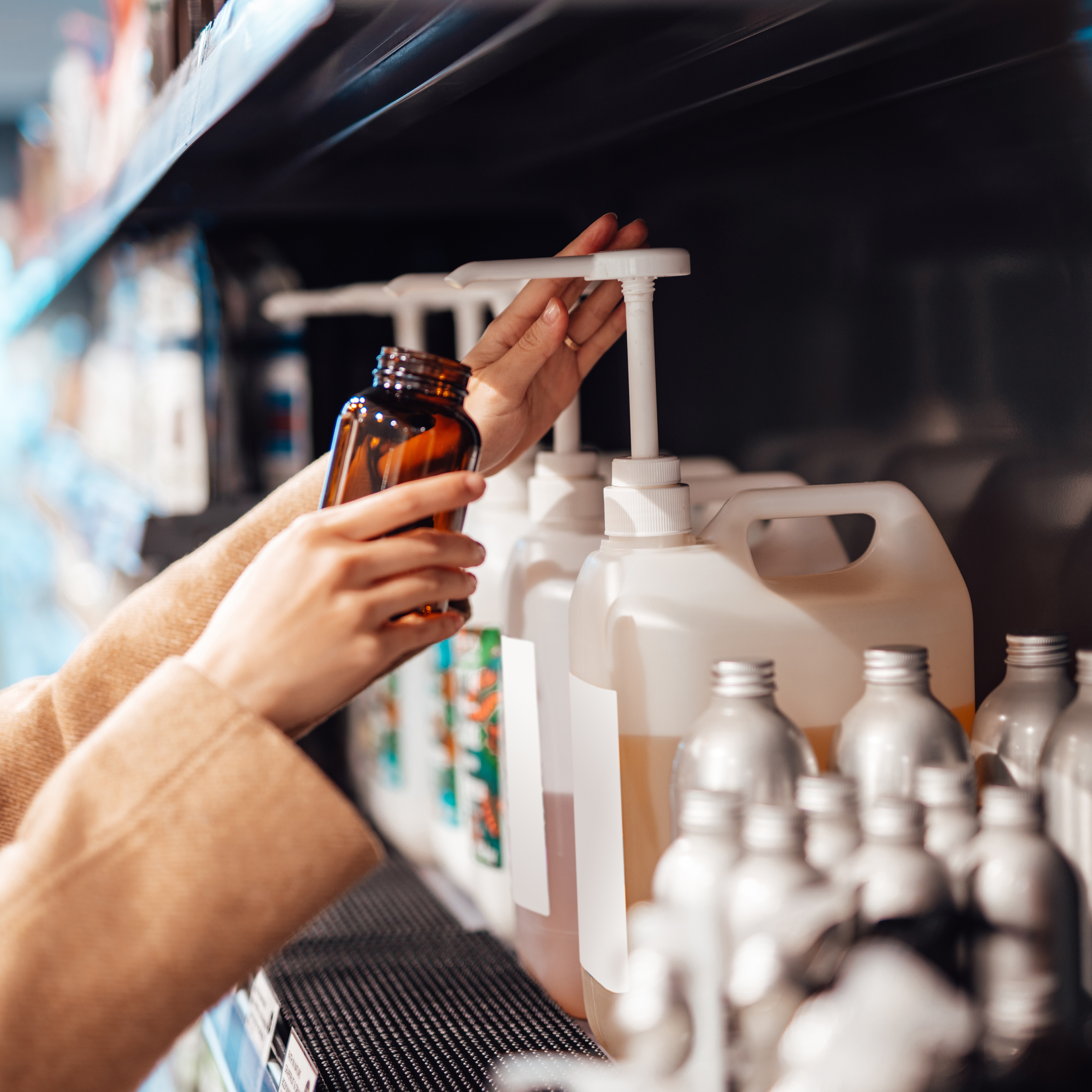 Person filling up a bottle with soap