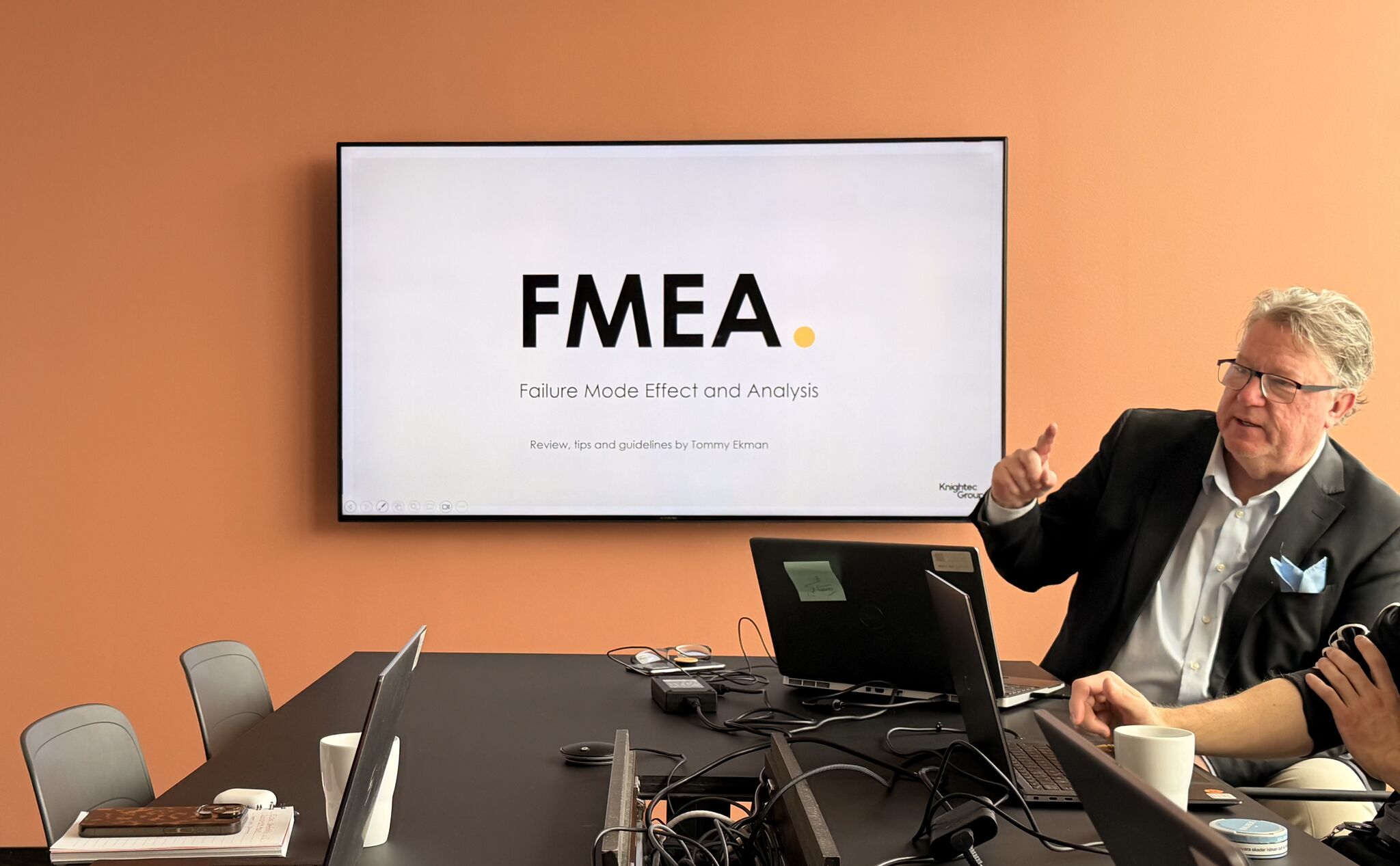 Person pointing at a computer screen