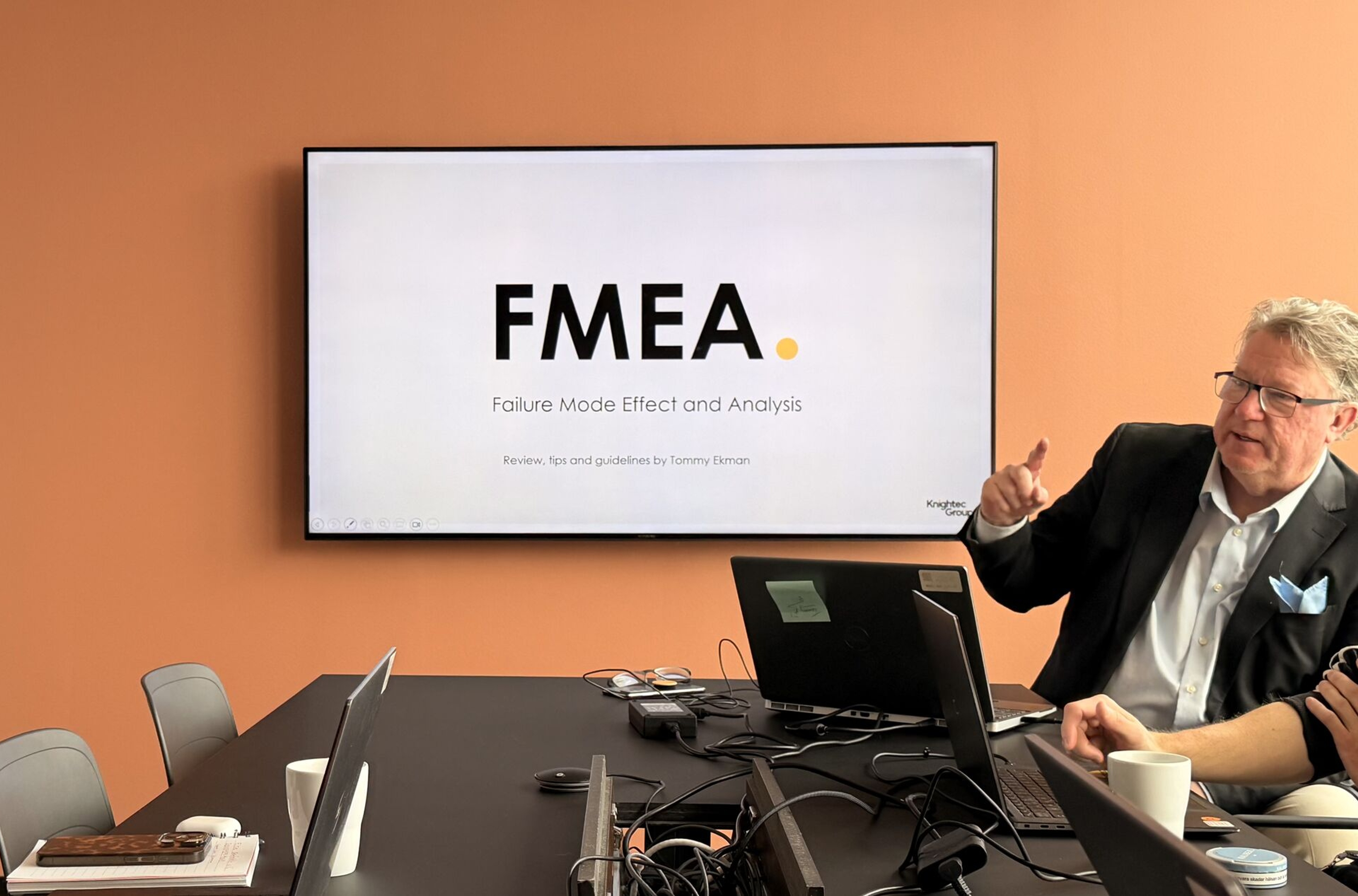 Person pointing at a computer screen