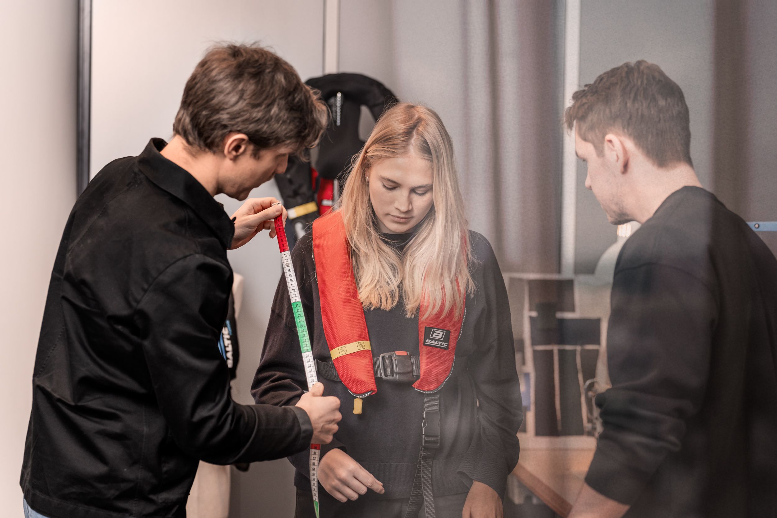 Three people looking at a life west