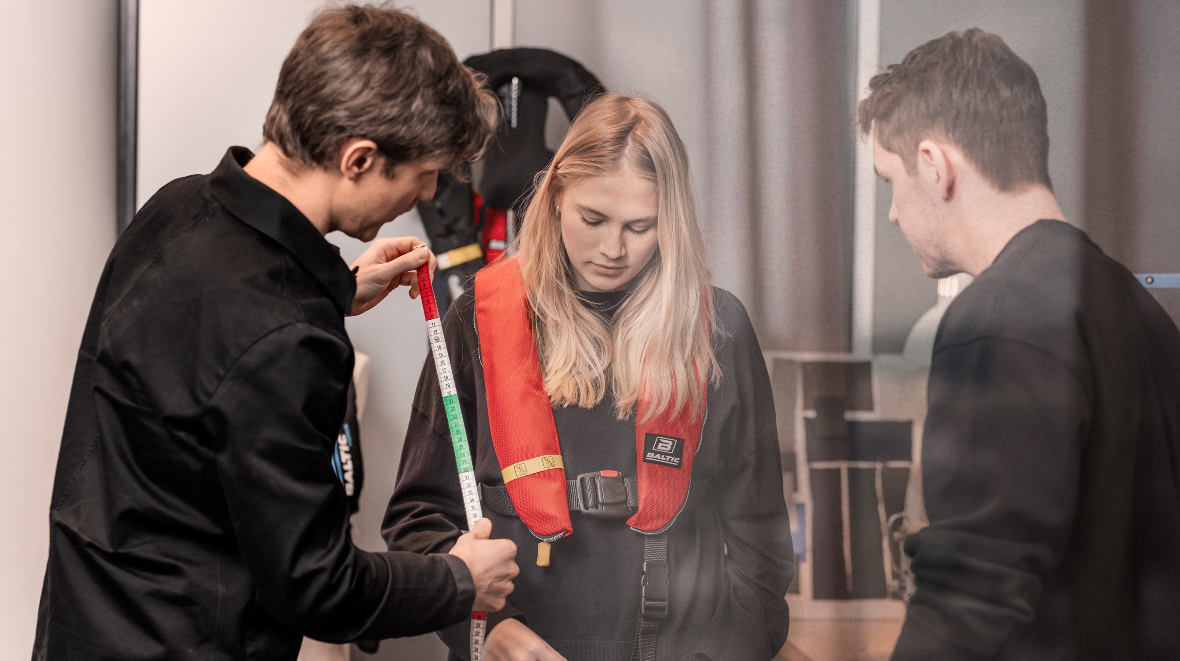 Three people looking at a life west