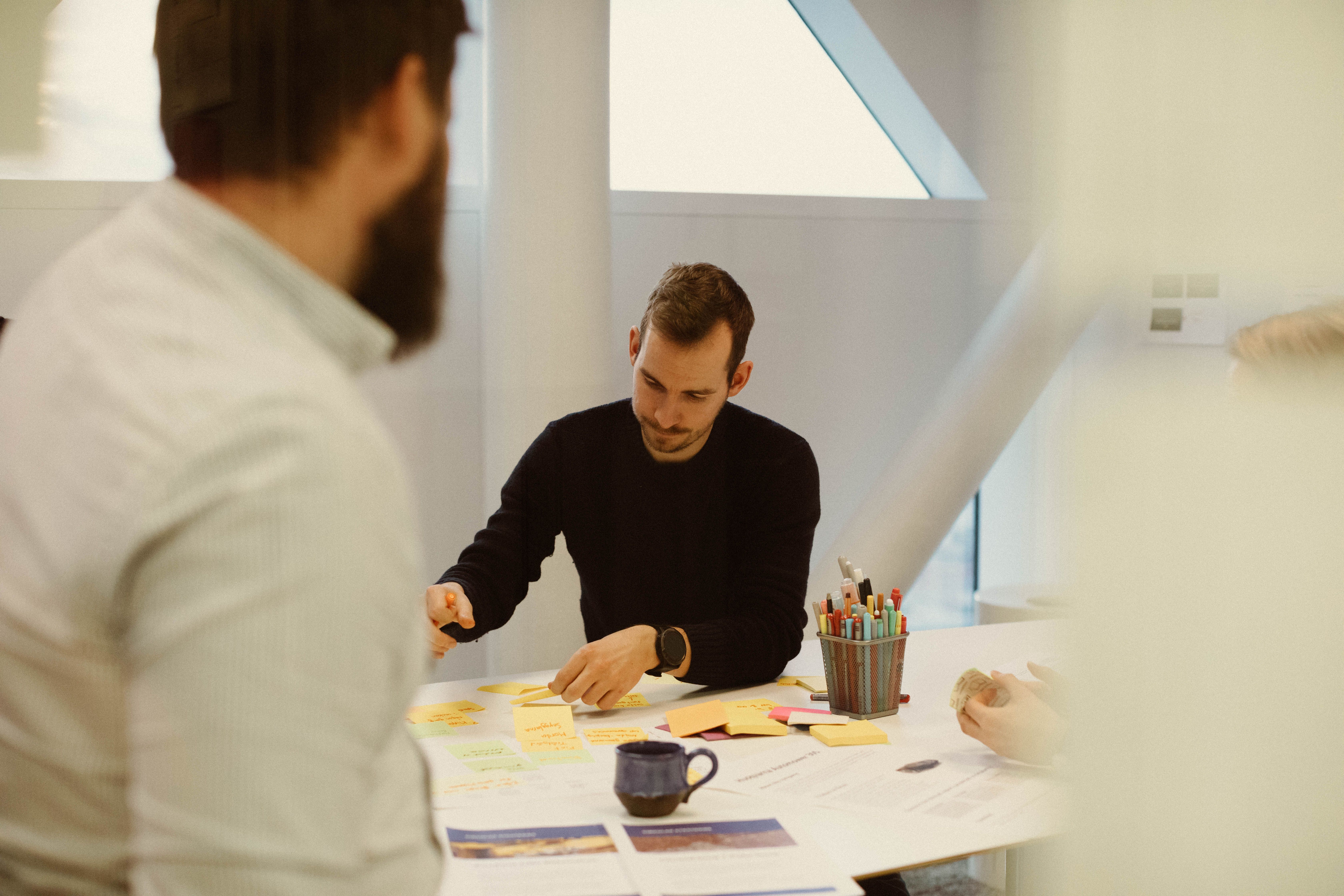 Two people working at a table with documents