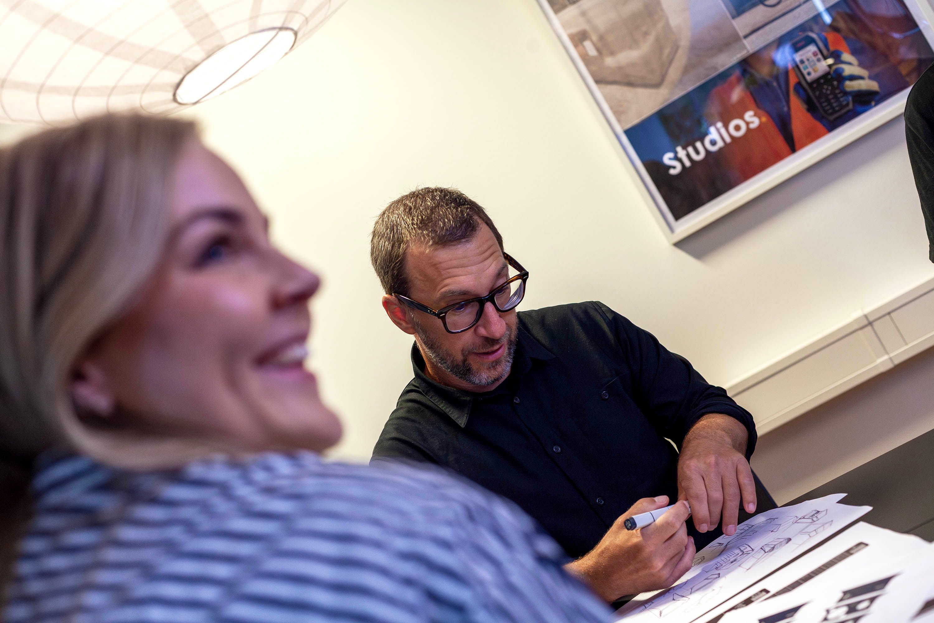Two people sketching on paper.