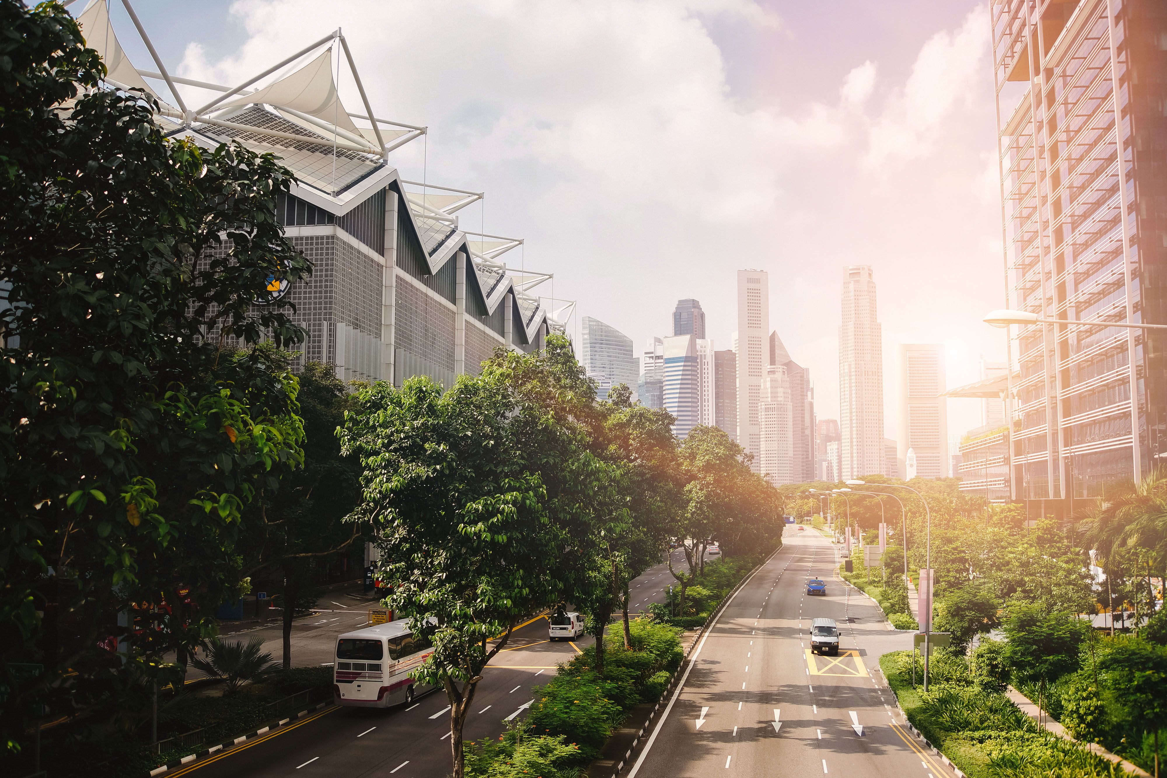 A road that runs through a city with a blue sky in the background