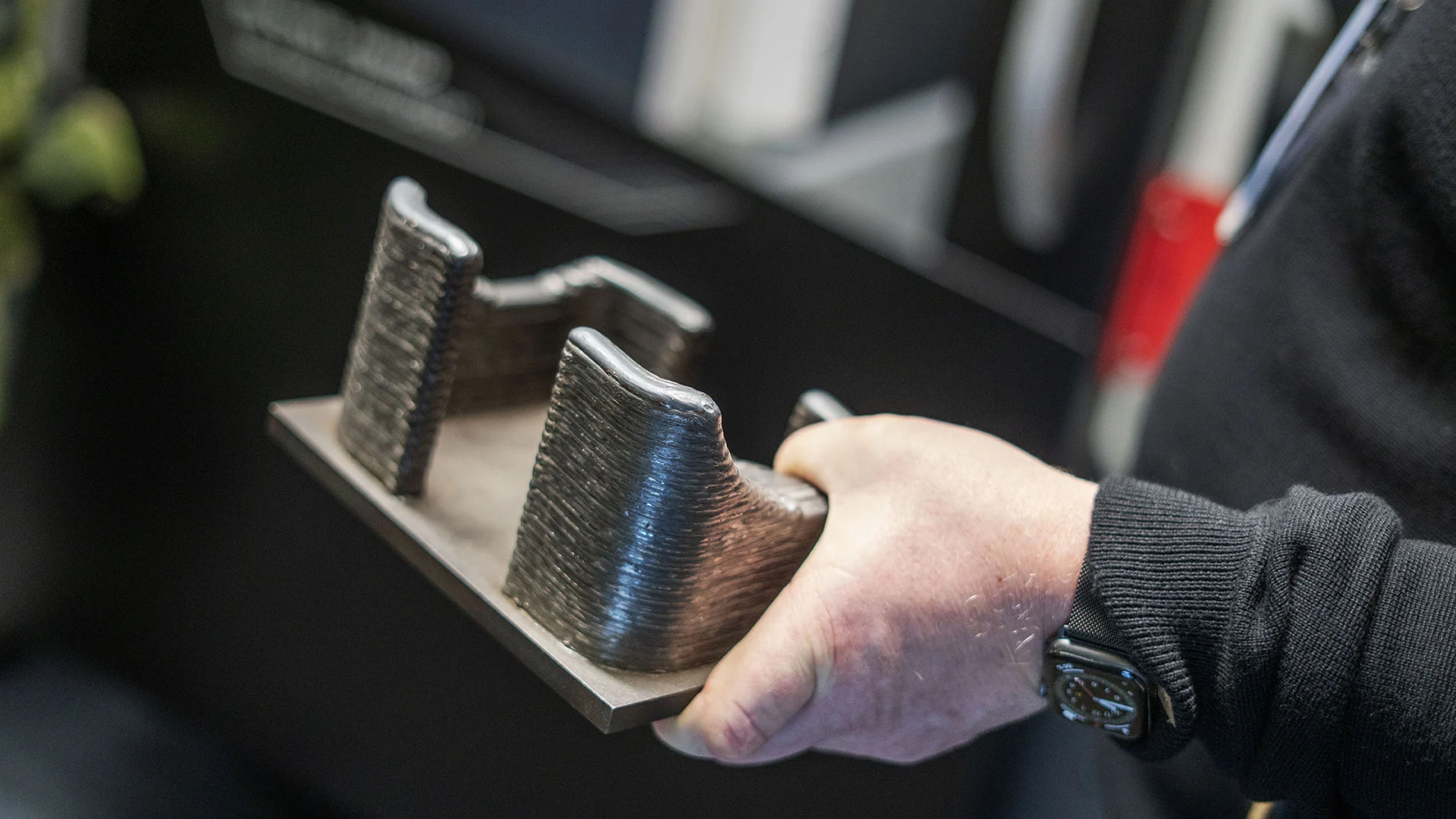 A person holding a 3D-printed part