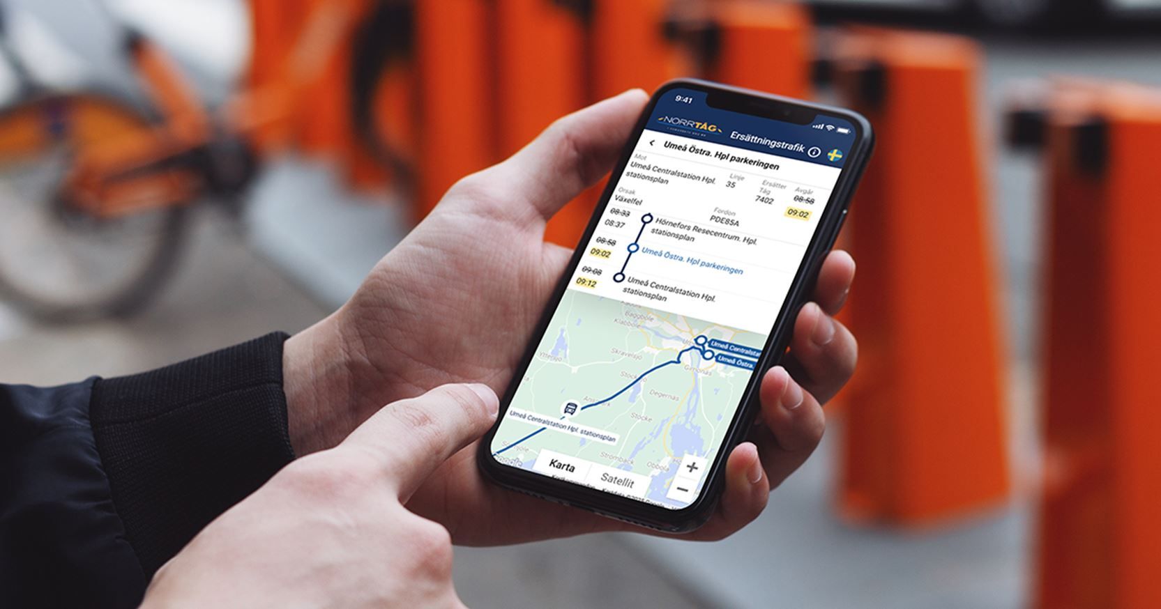 A person holding a cell phone and looking at a travel map