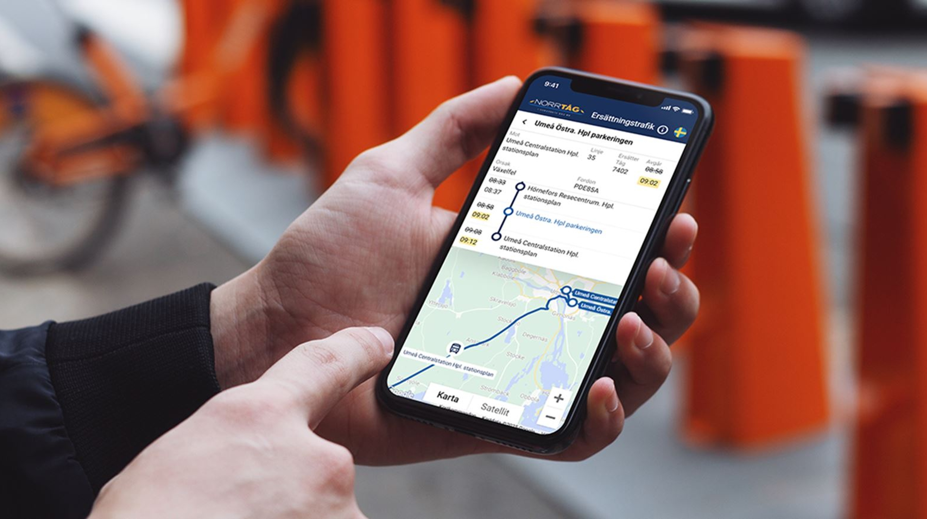 A person holding a cell phone and looking at a travel map