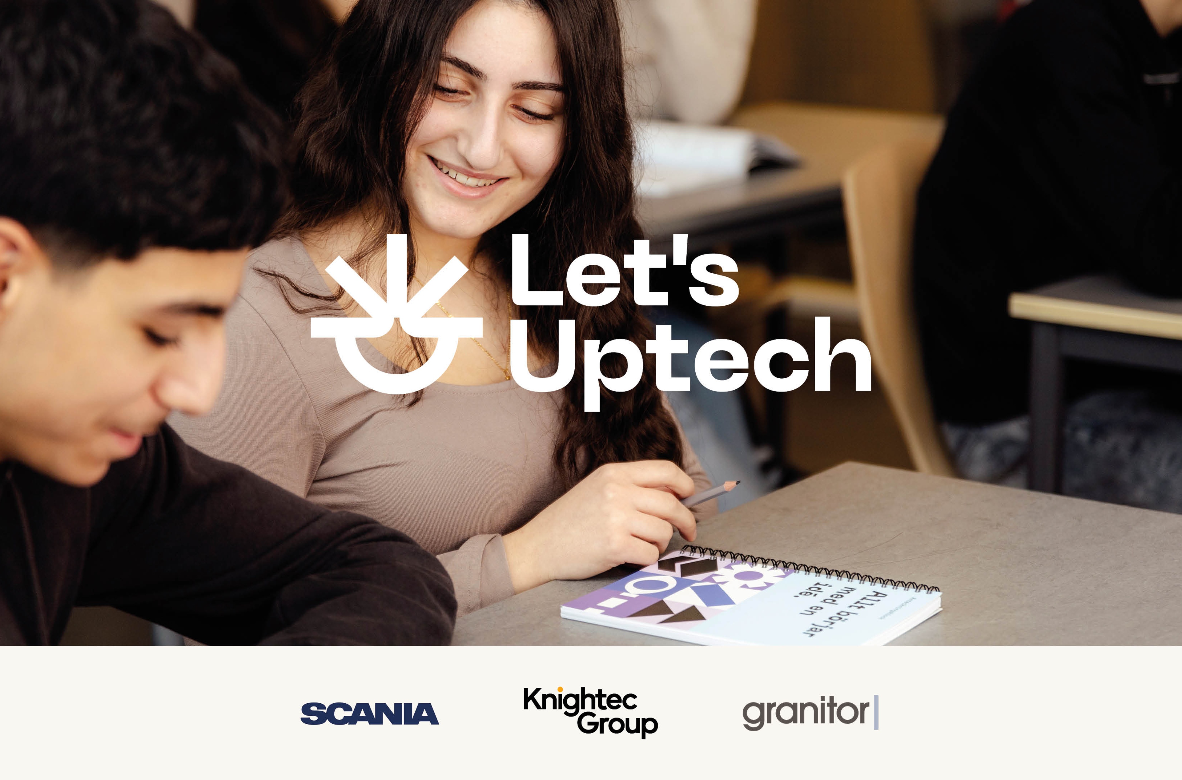 Dois estudantes sentados a uma carteira, com o texto Let's Uptech escrito sobre a imagem