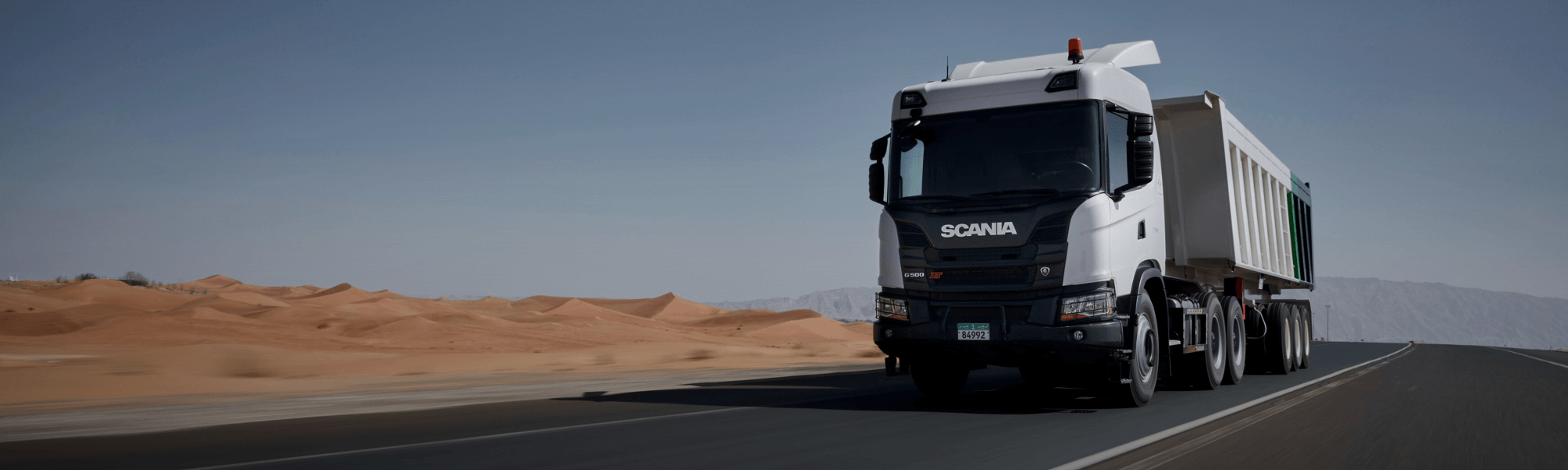 A canna truck driving on a road in the dessert