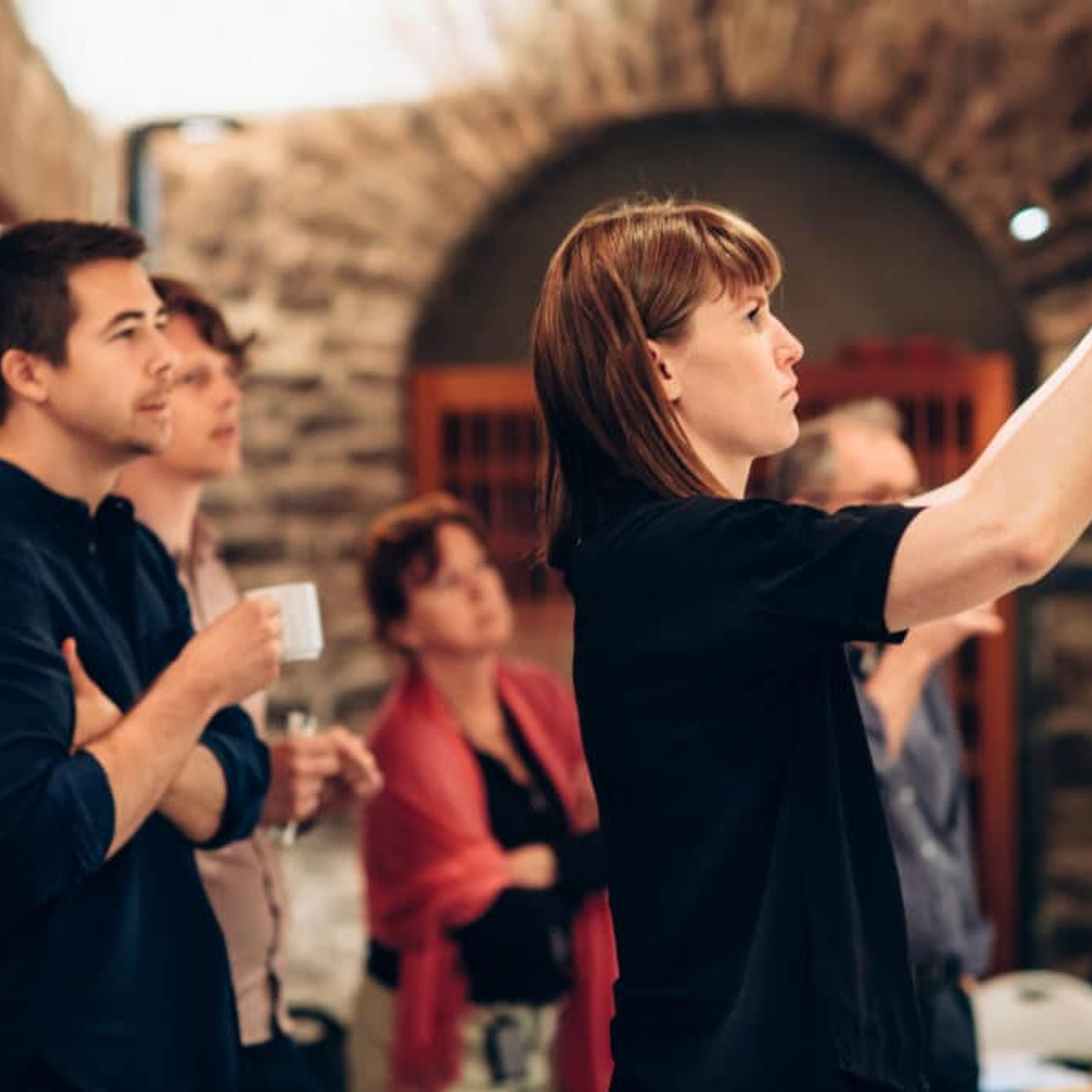 Image of a woman attaching a piece of paper on the wall