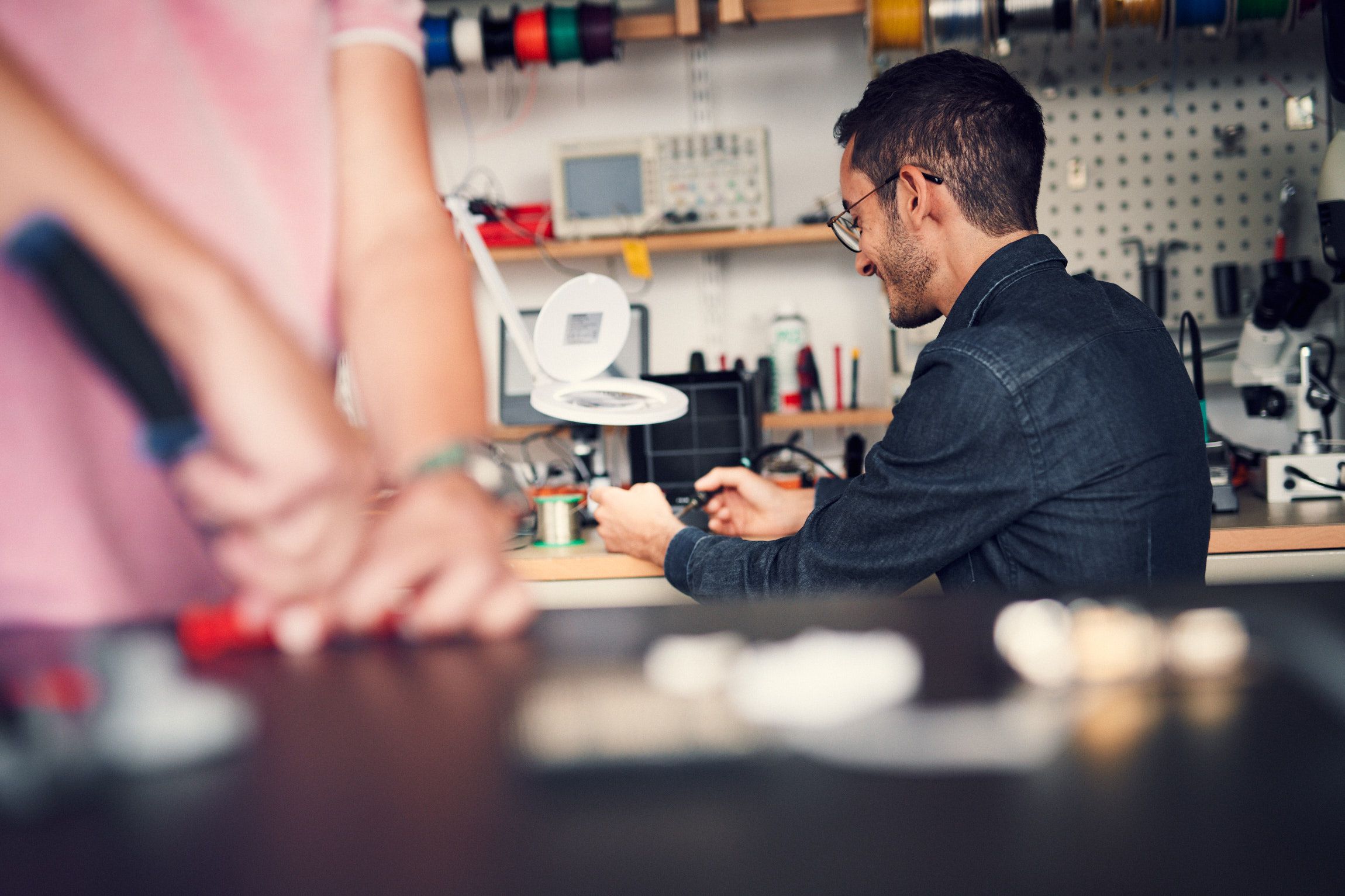 Two people in a workshop working on prototypes