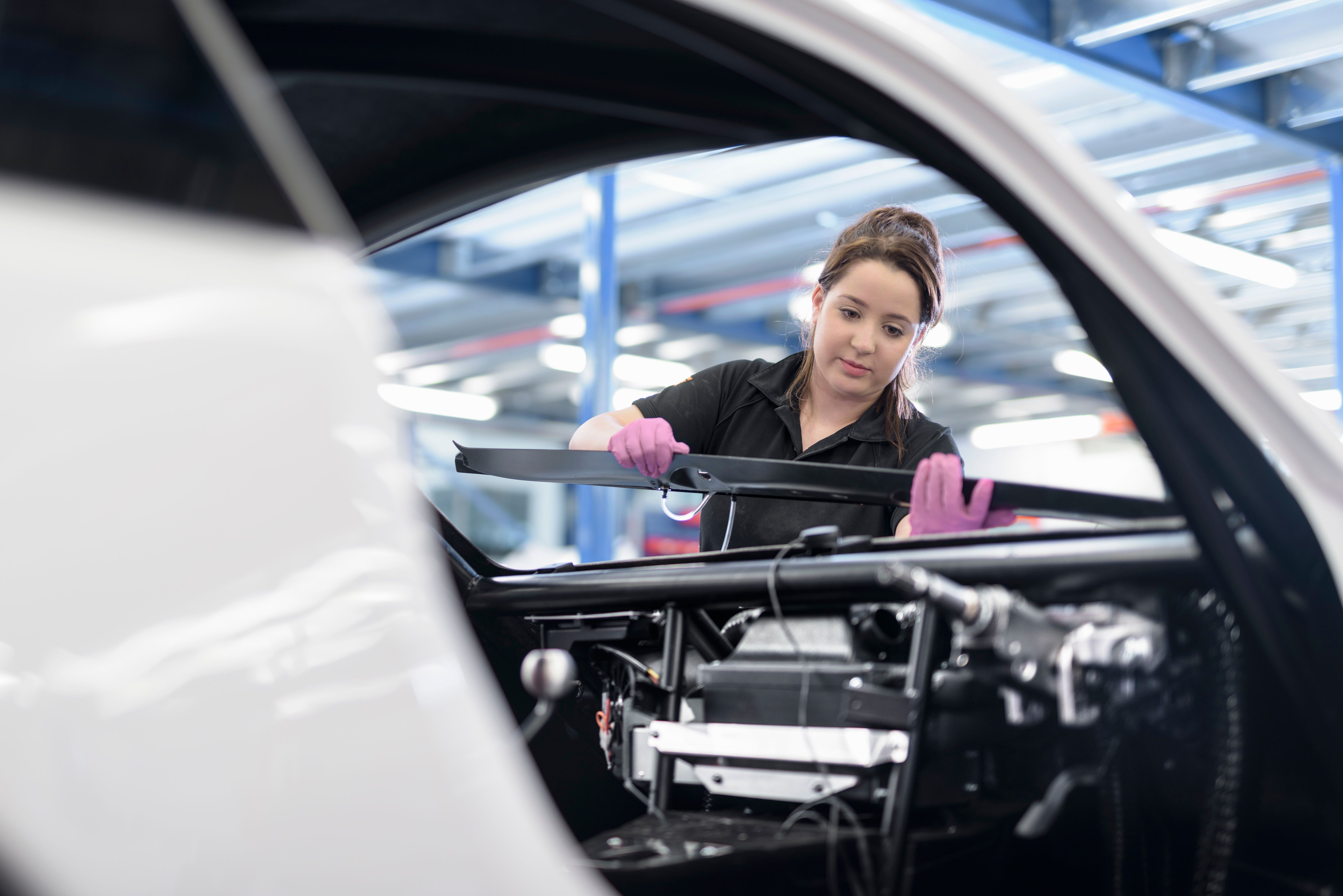 A women working in a production line for cars