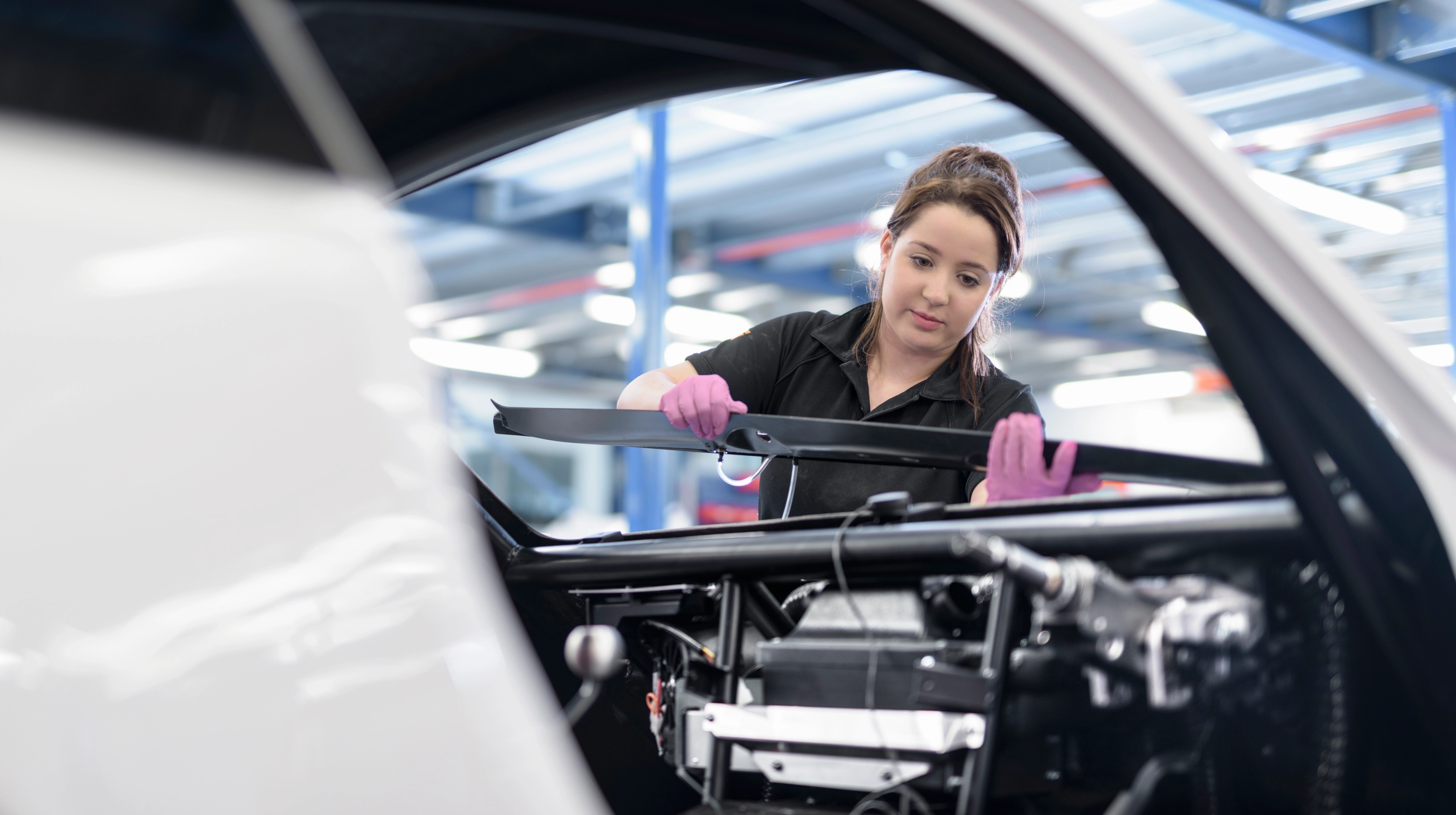 A women working in a production line for cars