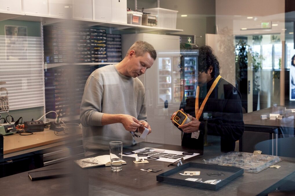 Two people working on prototypes at a workstation