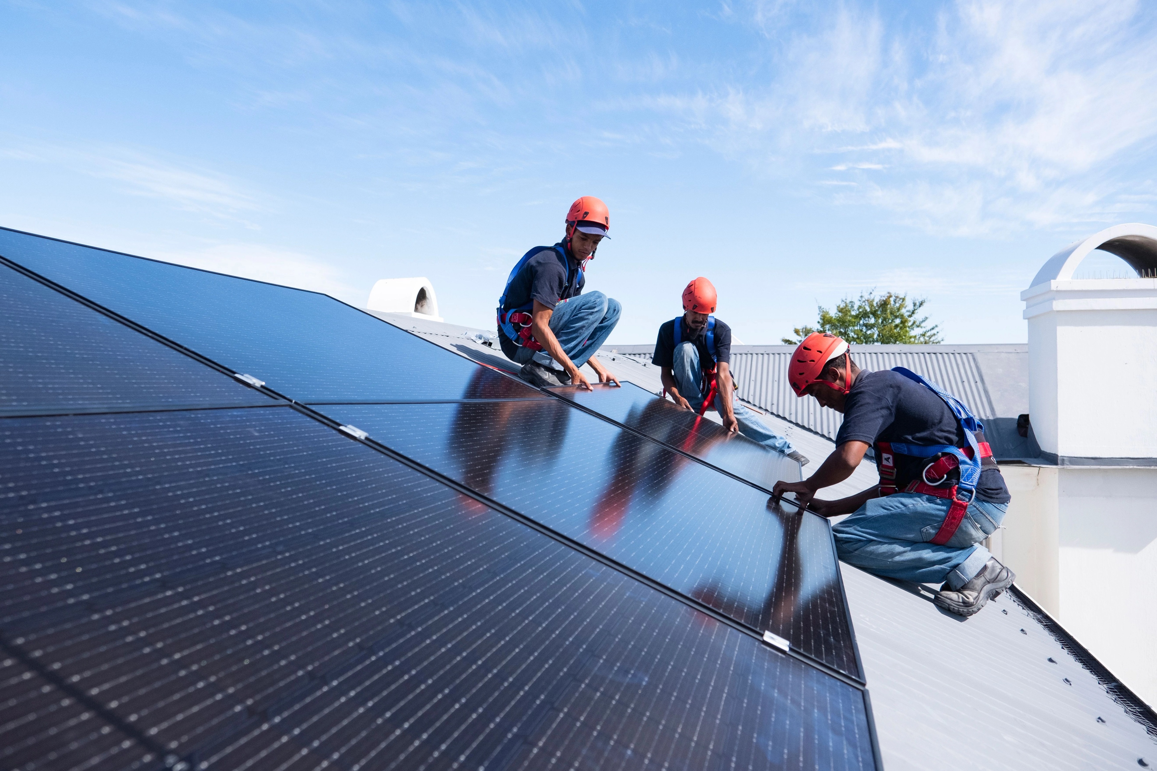 Image showing three workers installing solar panels
