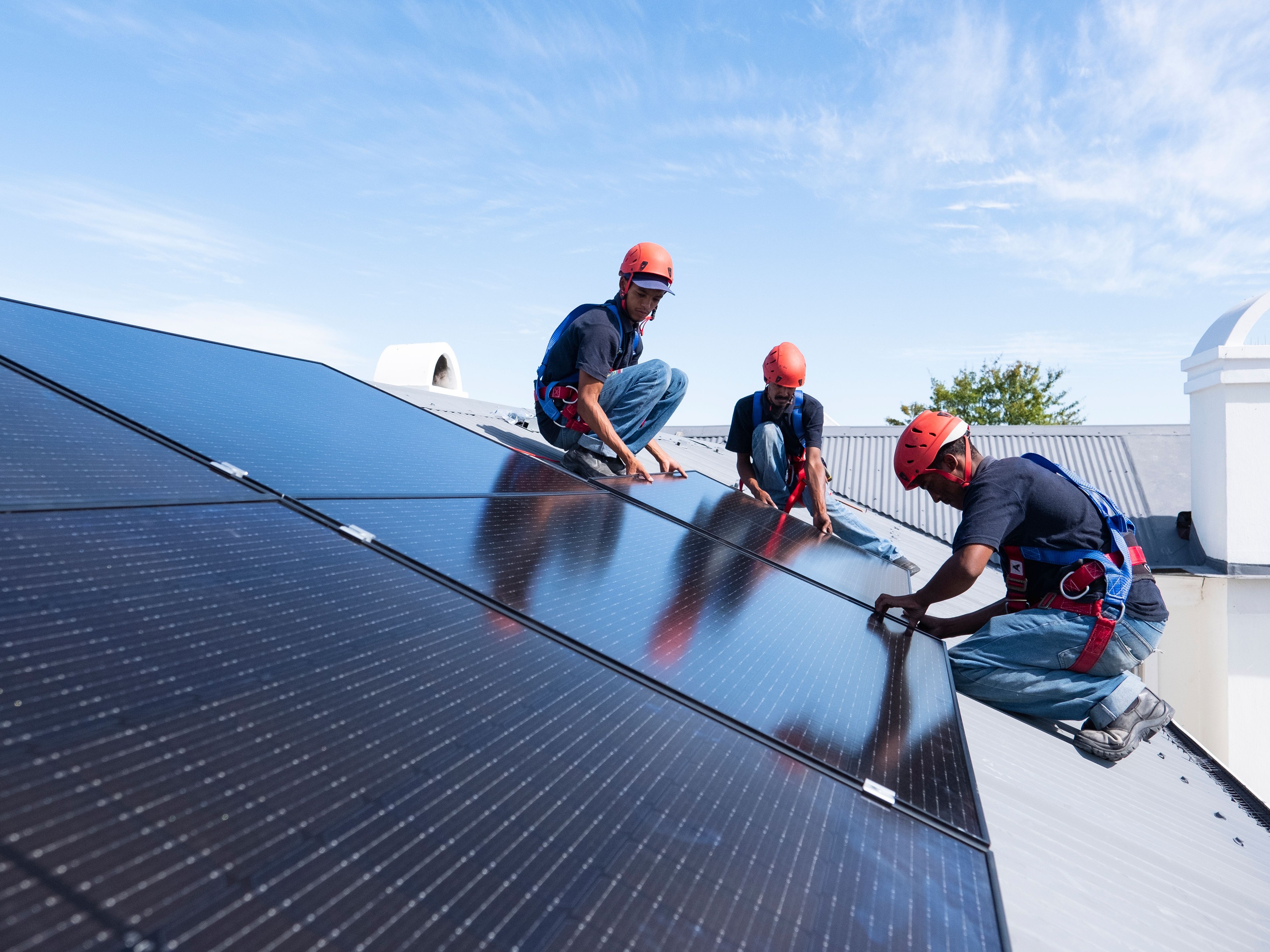 Image showing three workers installing solar panels