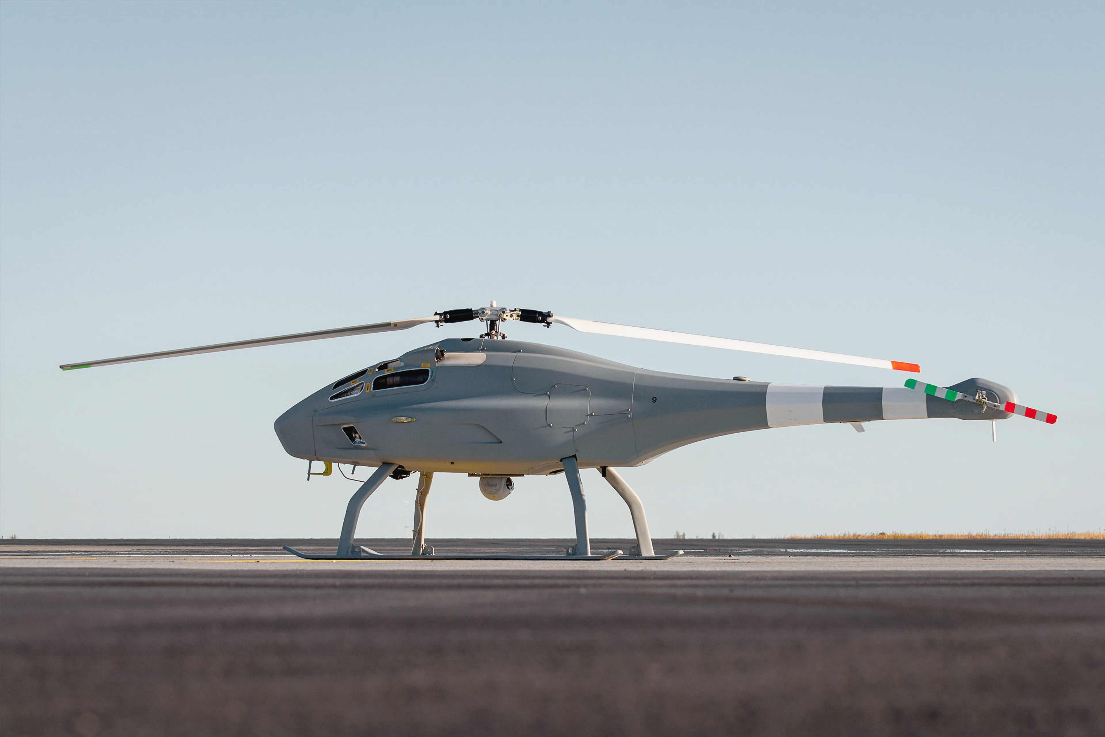 Unmanned helicopter drone positioned on a runway.