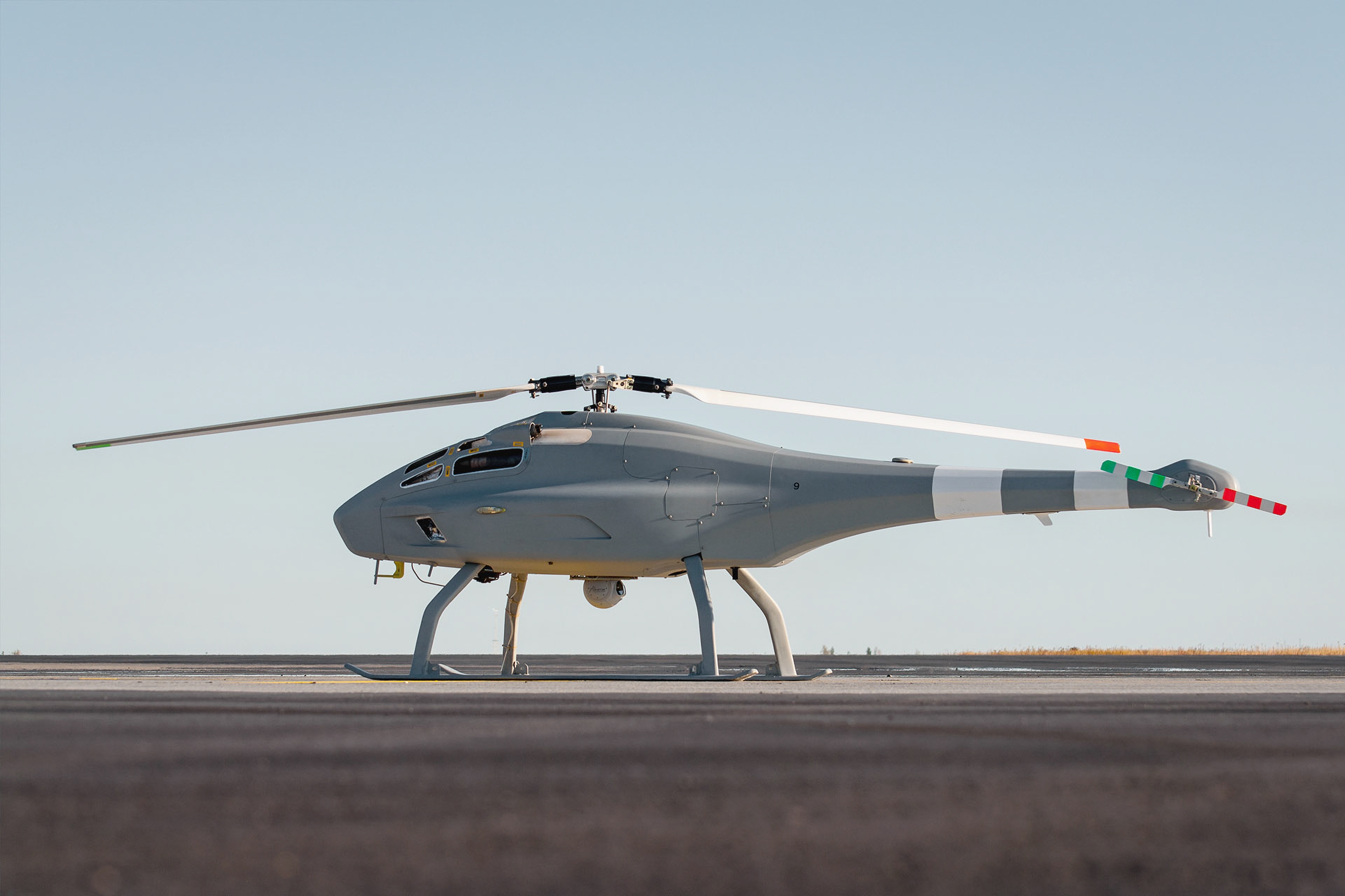 Unmanned helicopter drone positioned on a runway.