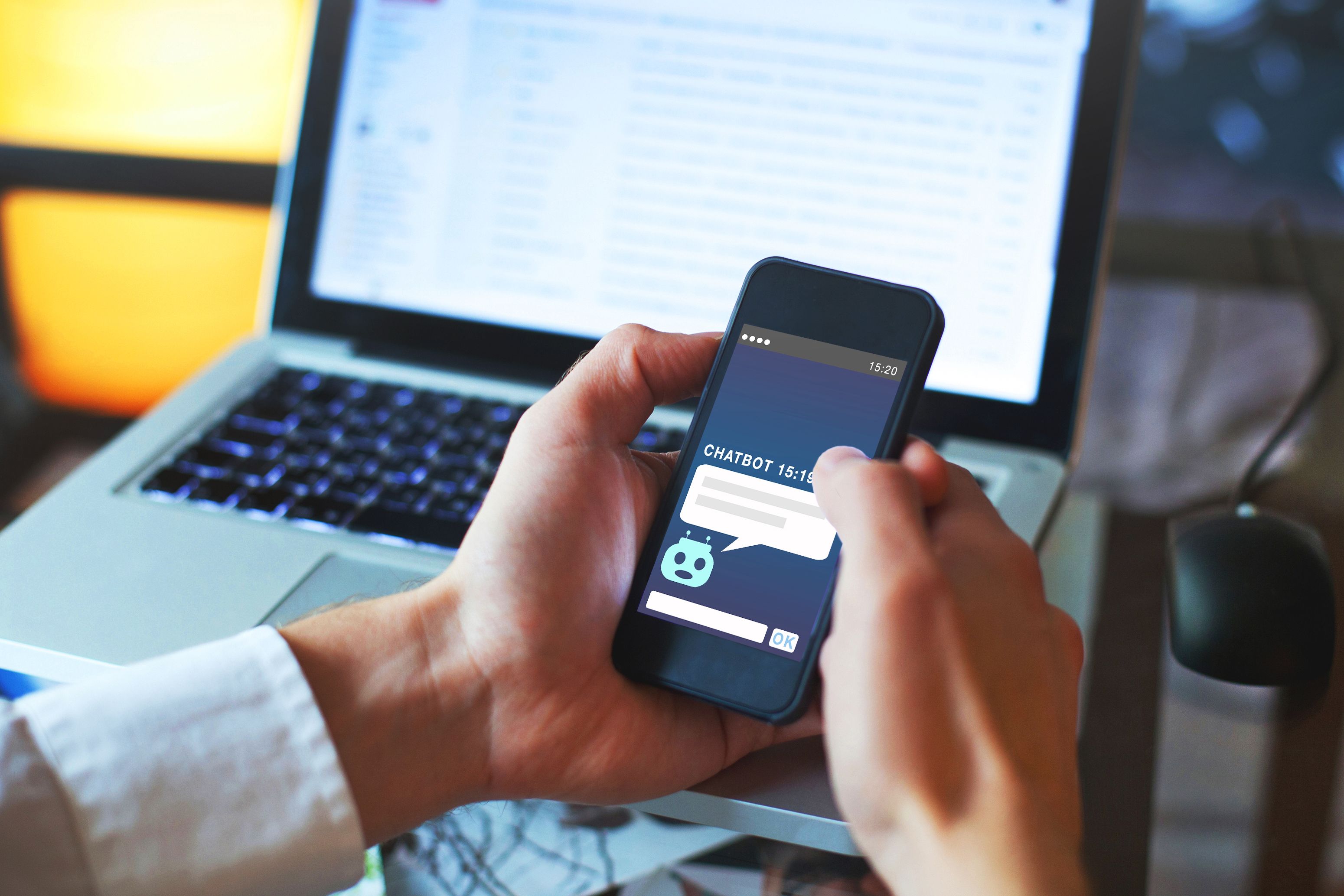 Person holding a phone with AI on the screen
