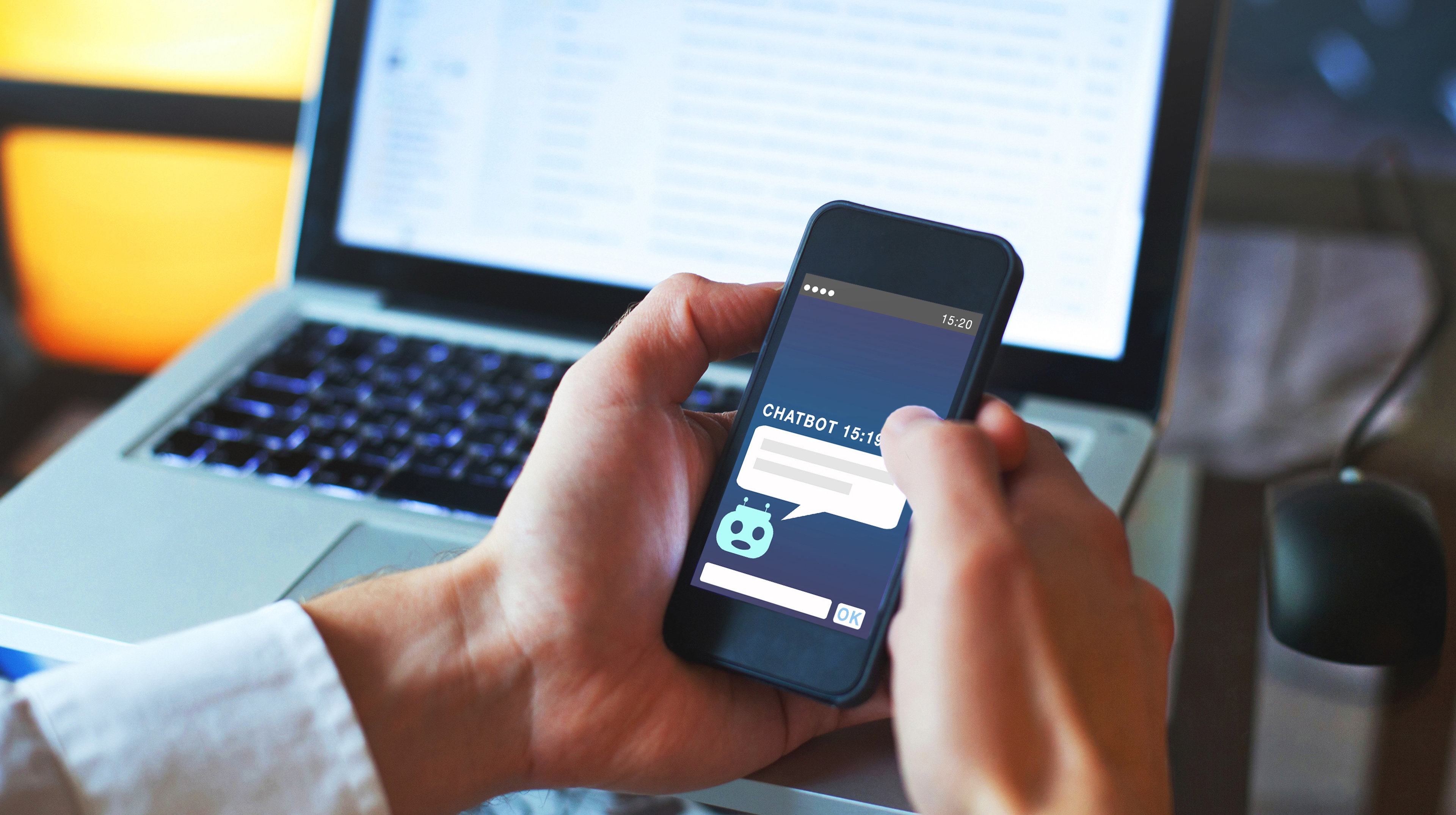 Person holding a phone with AI on the screen