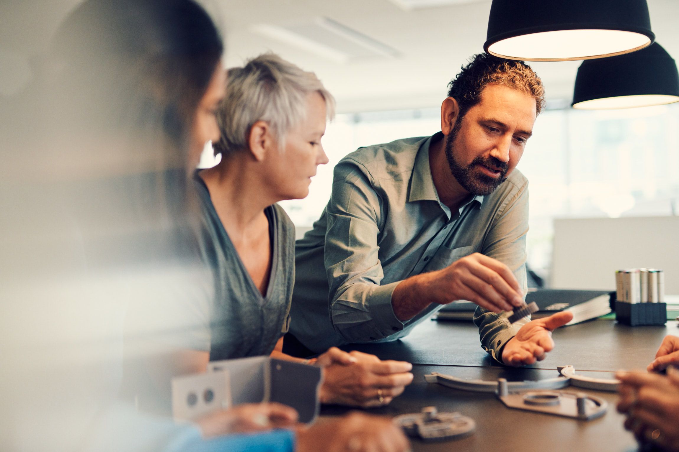 A group of people collaborating at a table with prototypes