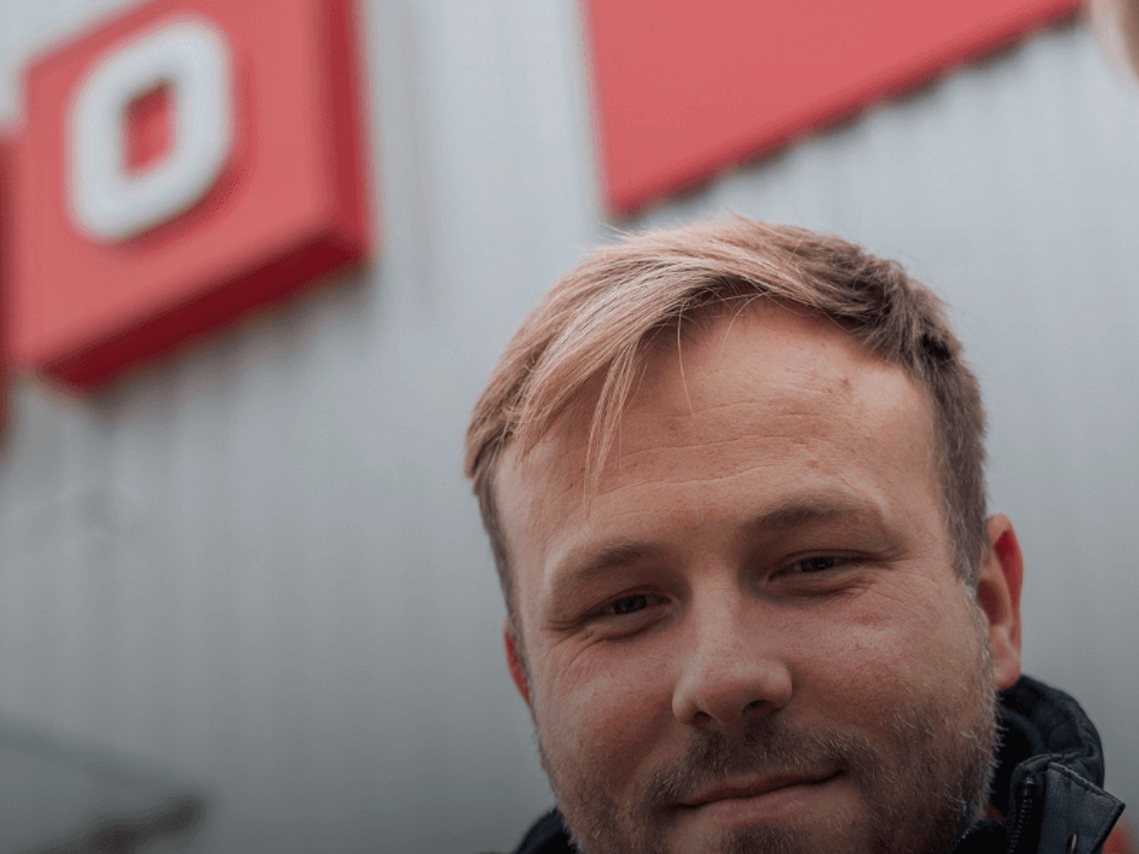 Three people standing outside a Cramo store