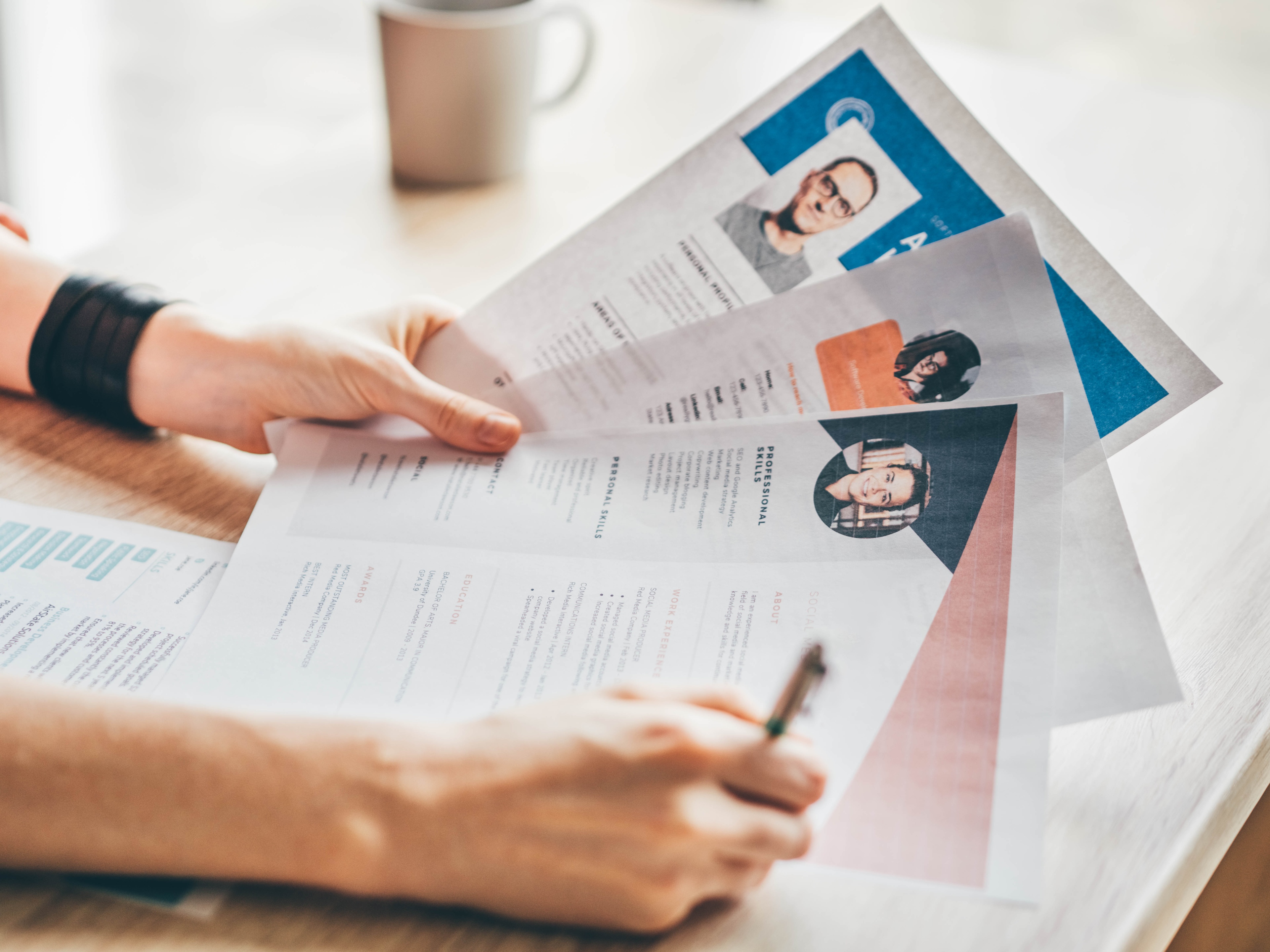 A women holding in 3 CV for hiring process