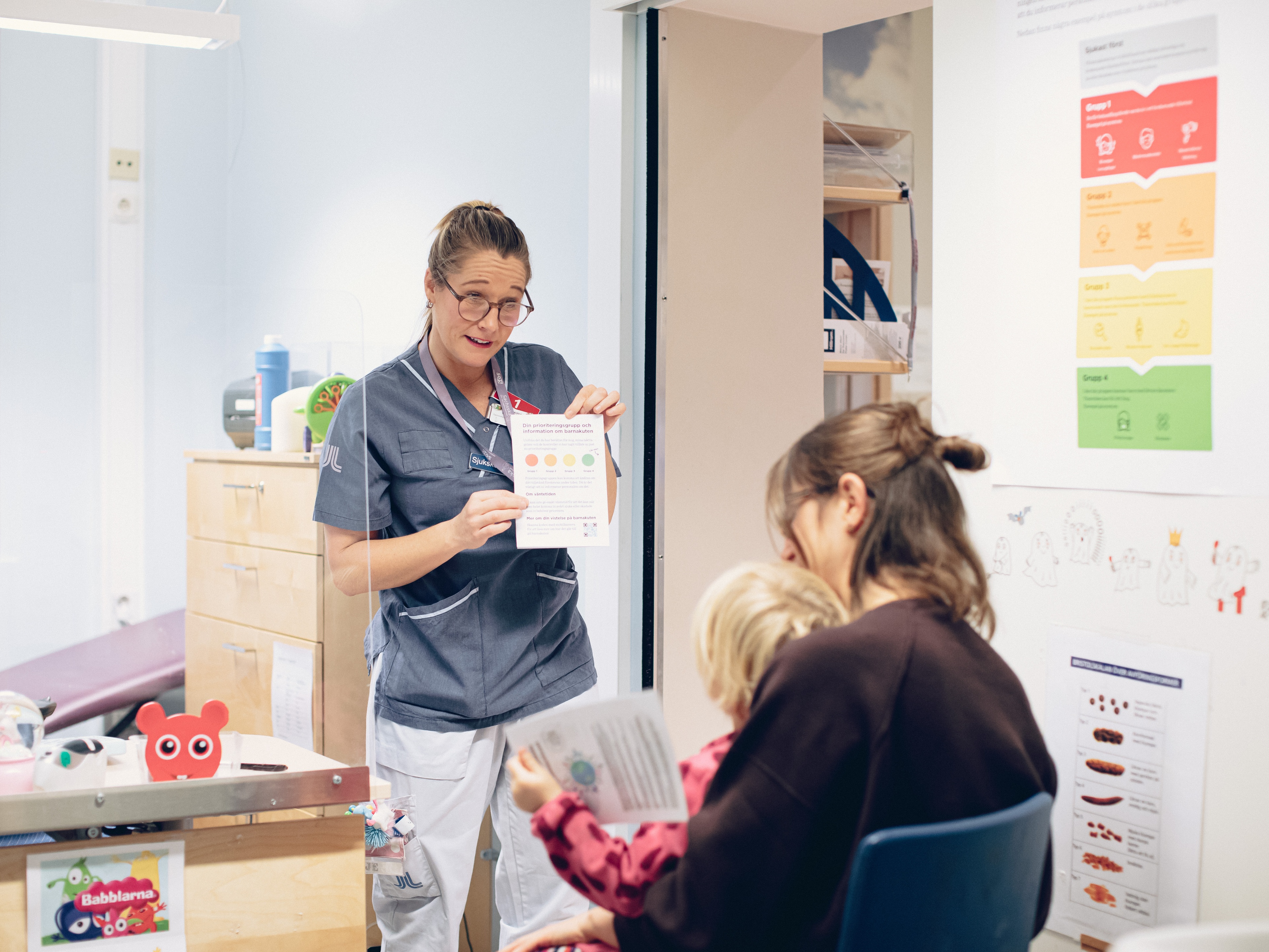 Waiting room at a hospital with three persons