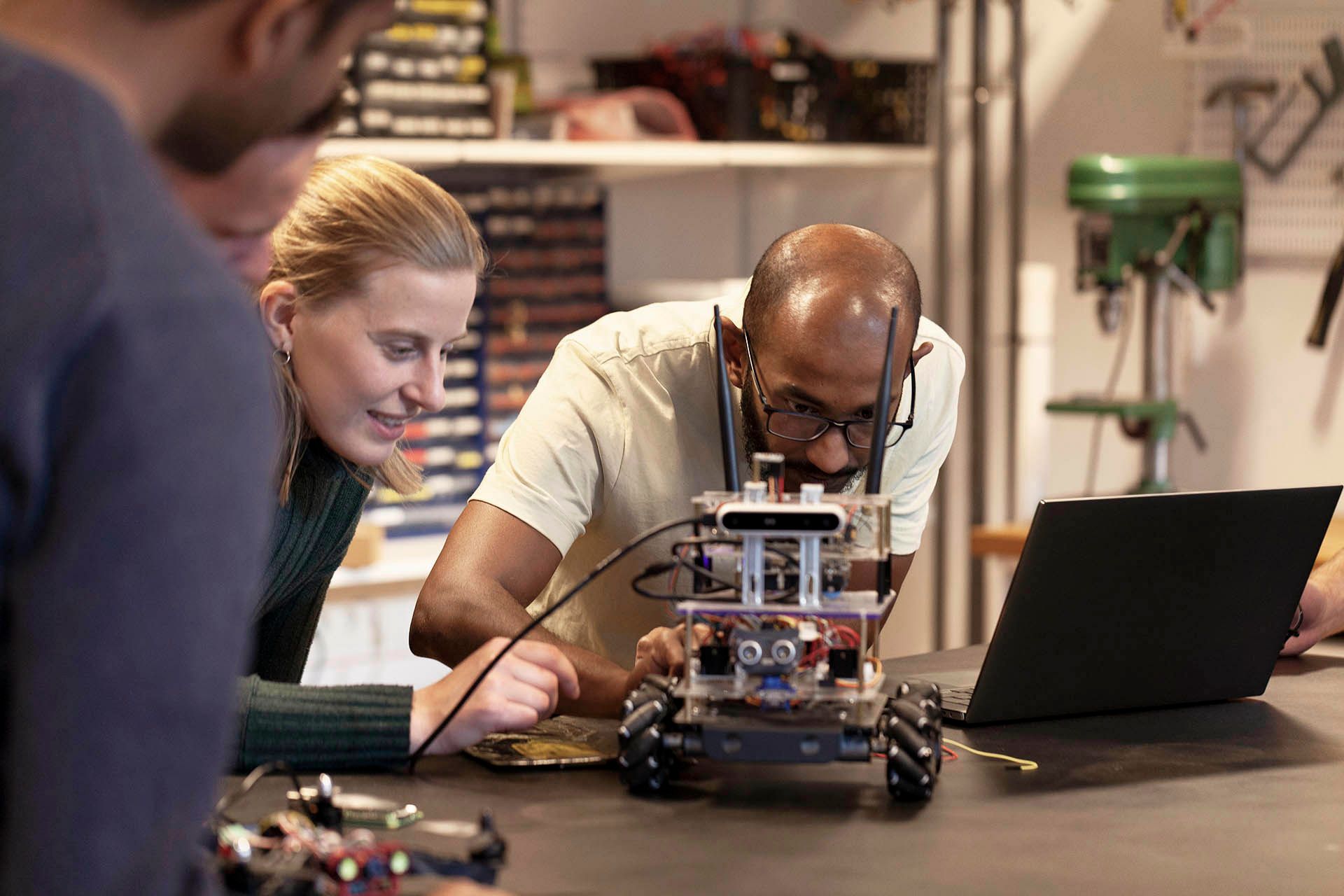 A group of people in a workshop working with prototypes