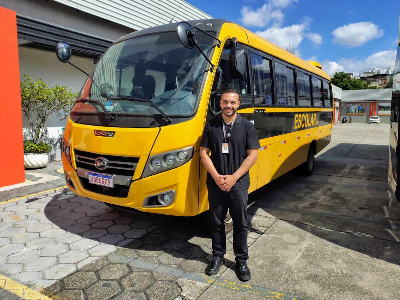 A man standing in front of a bus.