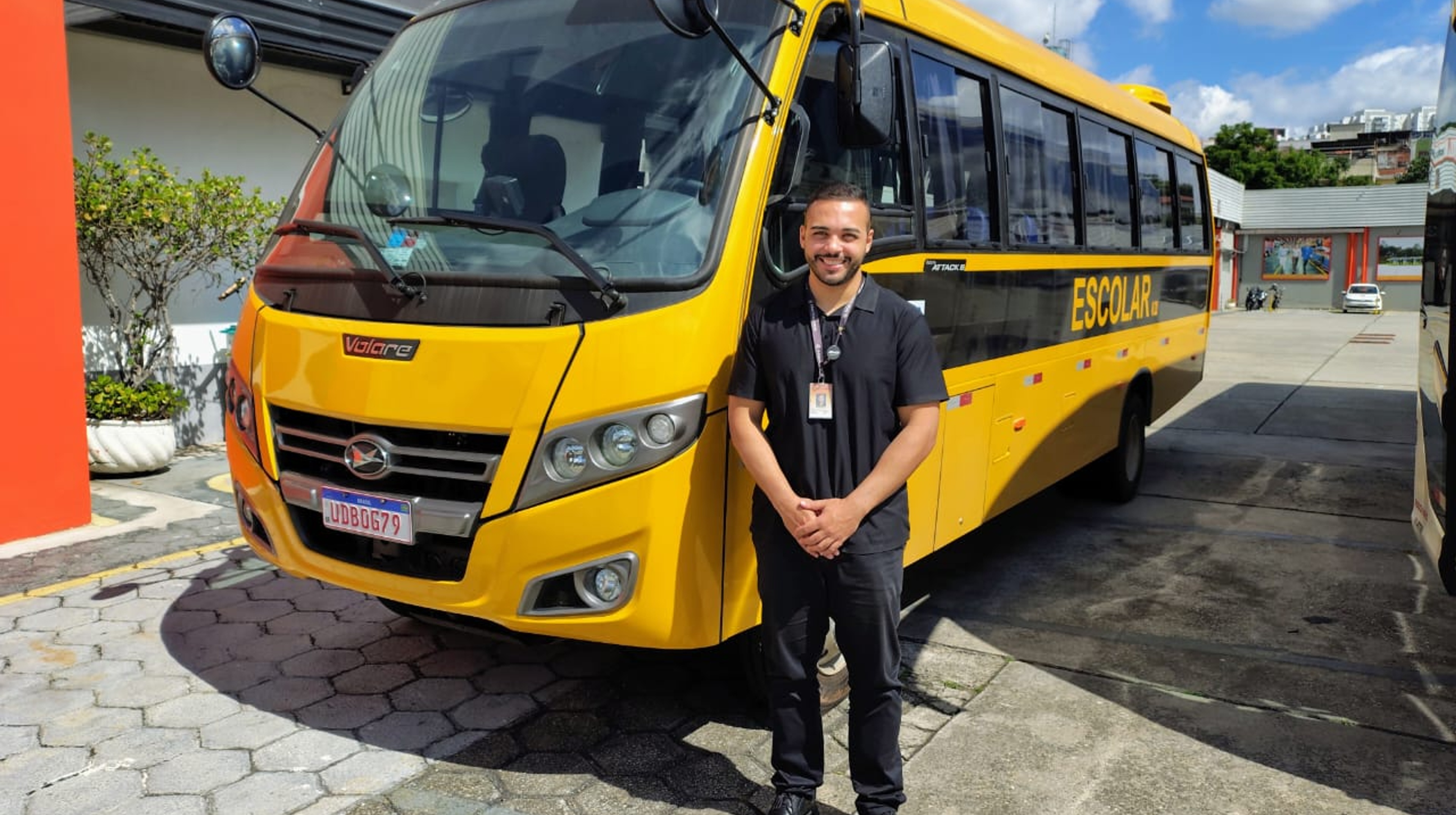 A man standing in front of a bus.