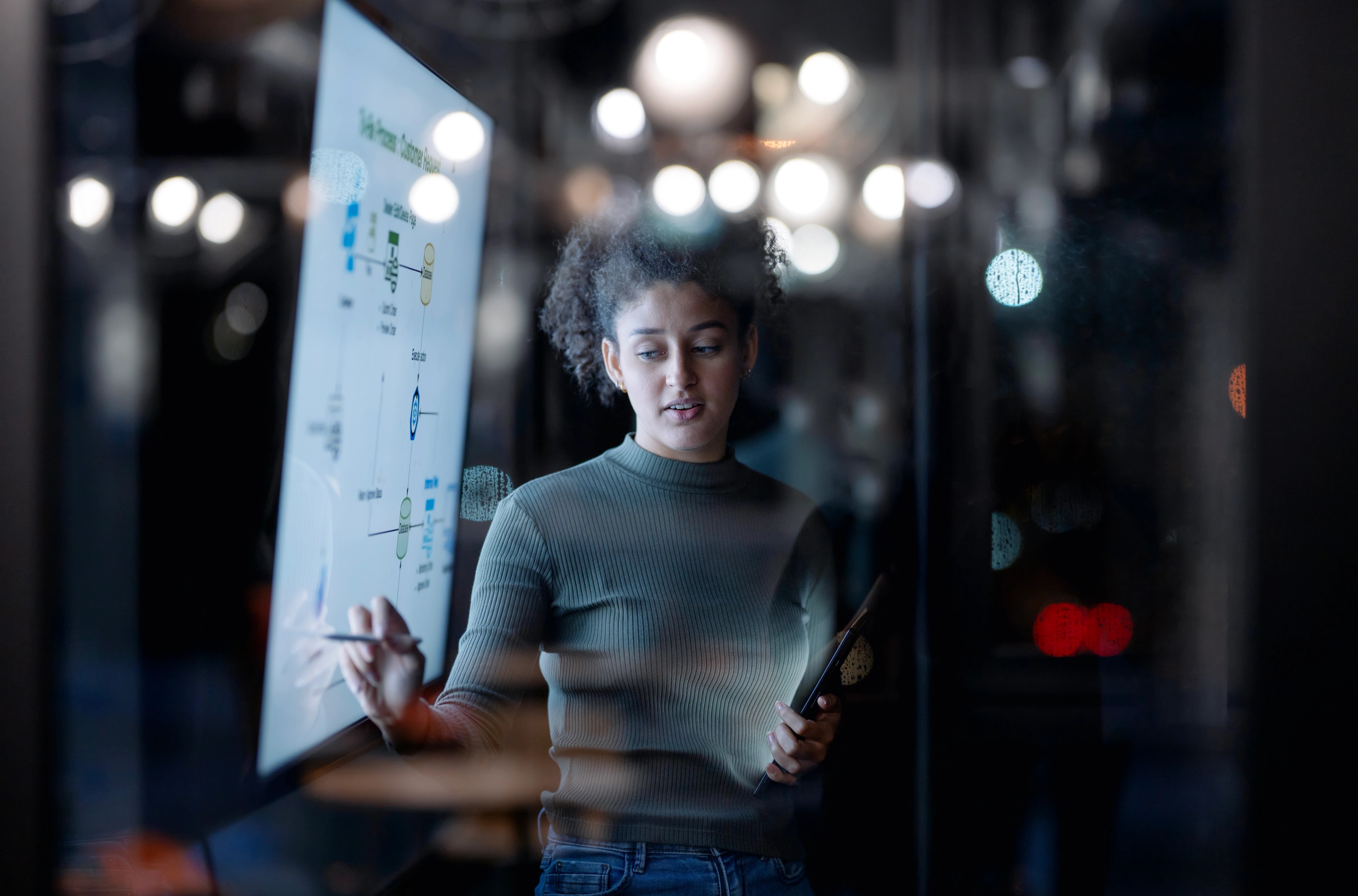 One women standing in front of a screen