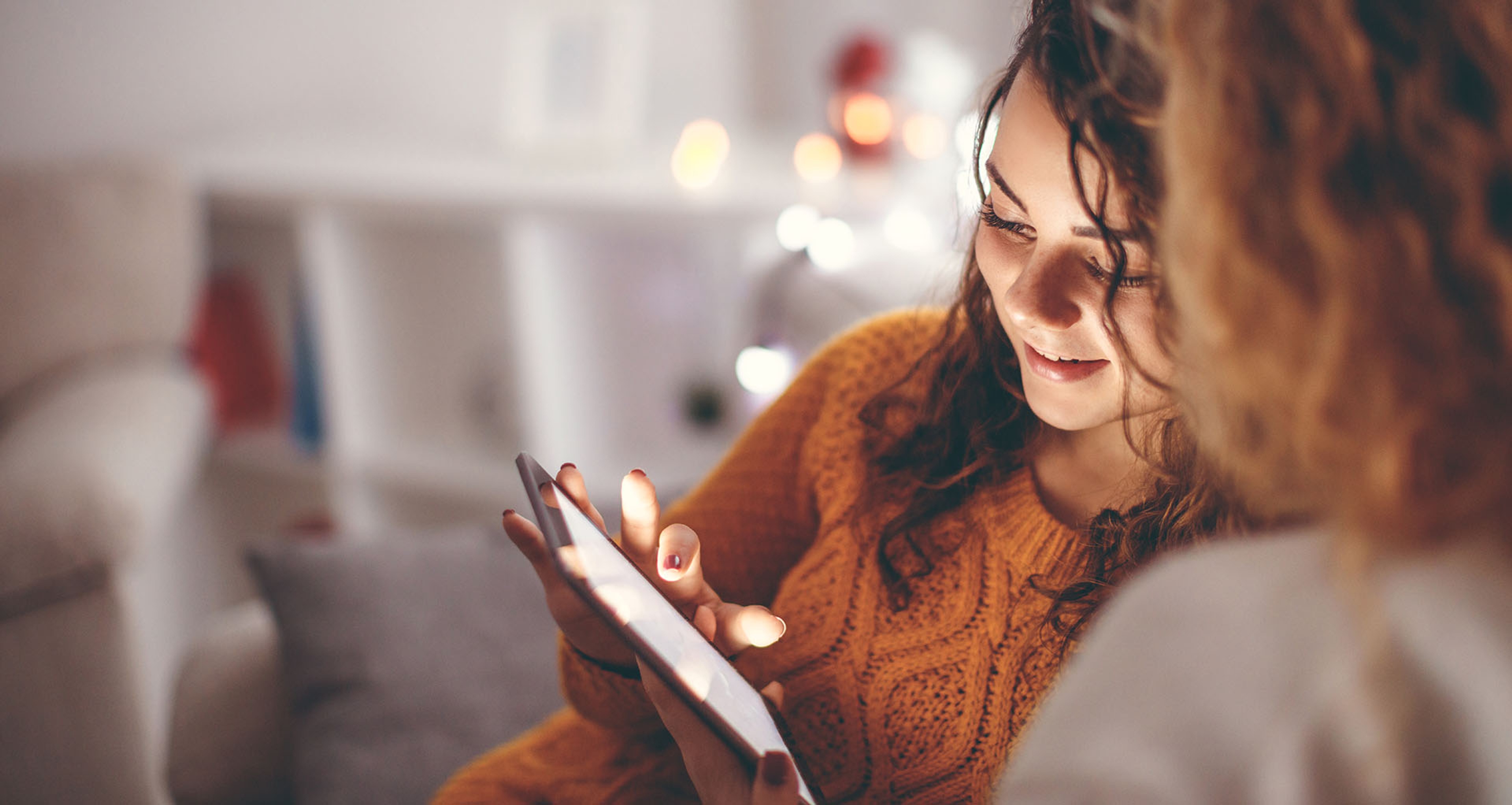 A women looking at an iPad.