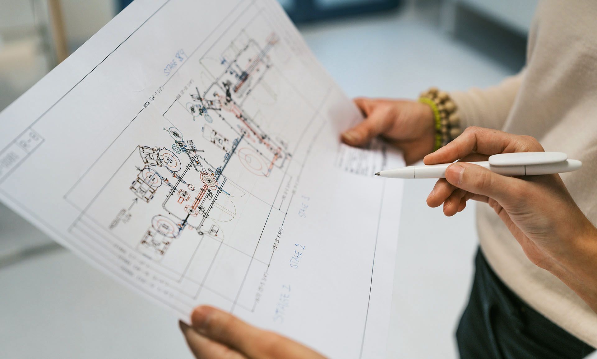 Hands holding a technical drawing