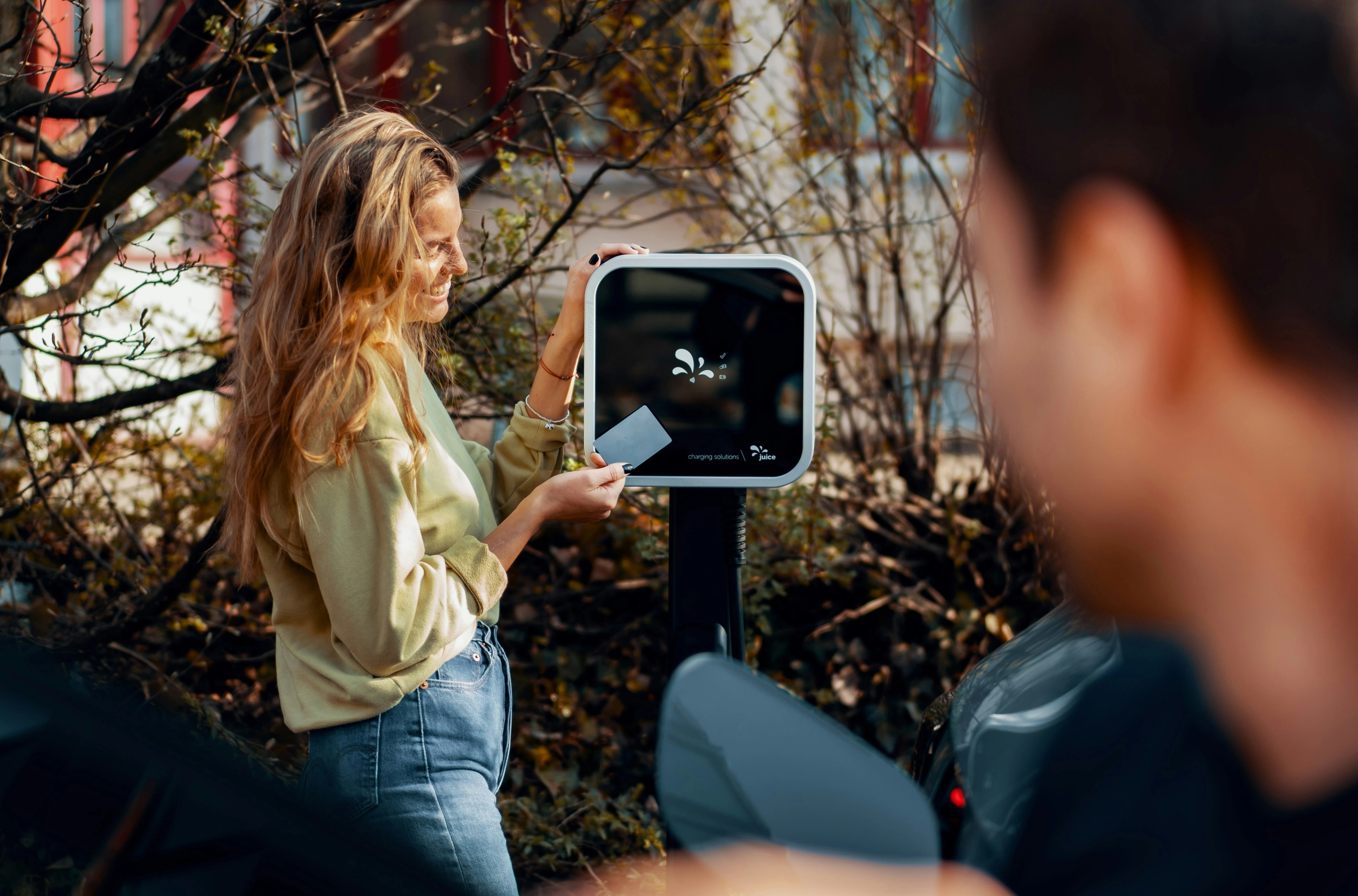 A woman paying for EV-charging.