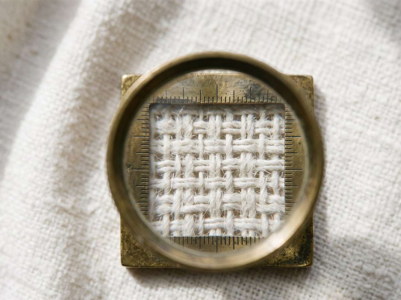 Counting threads per inch through a pick glass on plain-woven cotton