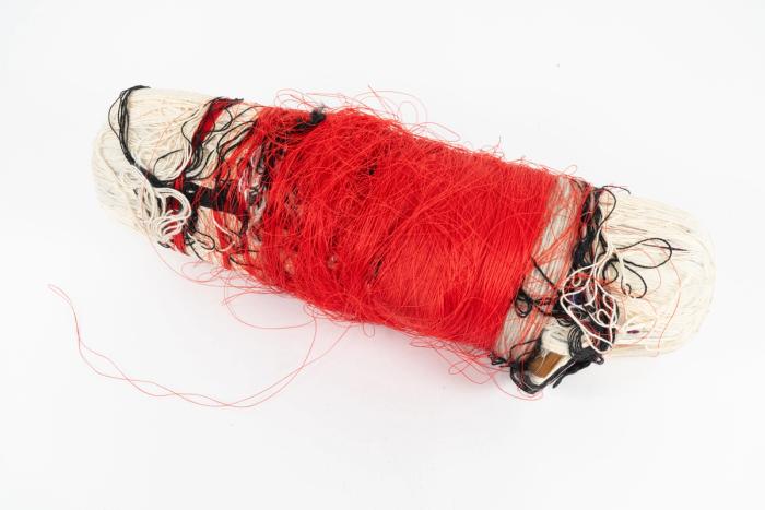 An abstract, mixed media sculpture made with cardboard, polyester thread, cotton twine, masking tape, acrylic beads, and pencils. 