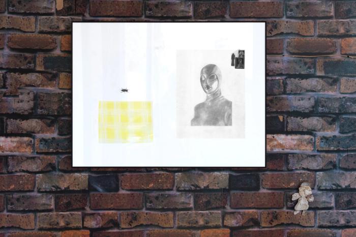 a view of two artworks installed on a wall thats covered in a large vinyl sticker printed to look like brick. there is a larger framed artwork with several pieces collaged togerher including a yellow textile and a very naturalistic graphite drawing of a person in a fly costume. below and to the right is a small sculpture made of coral in the shape of an angel