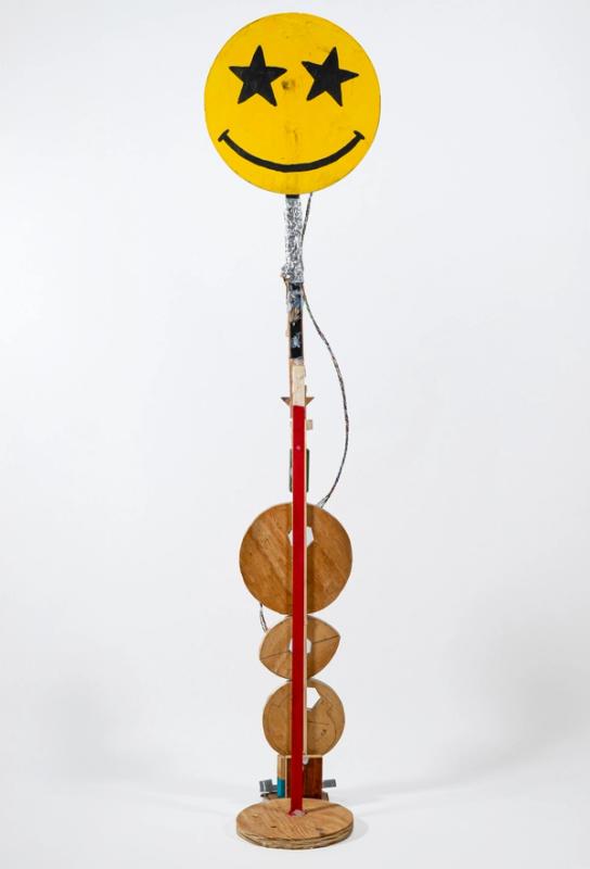 Conceptual sculpture with a smiley face design on a white background