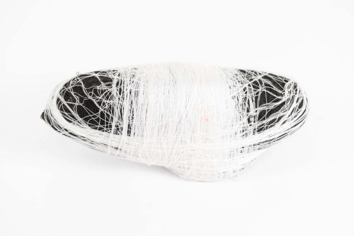 An abstract, mixed media sculpture made with polyester thread, cotton twine, wood, cardboard, and paint brushes.